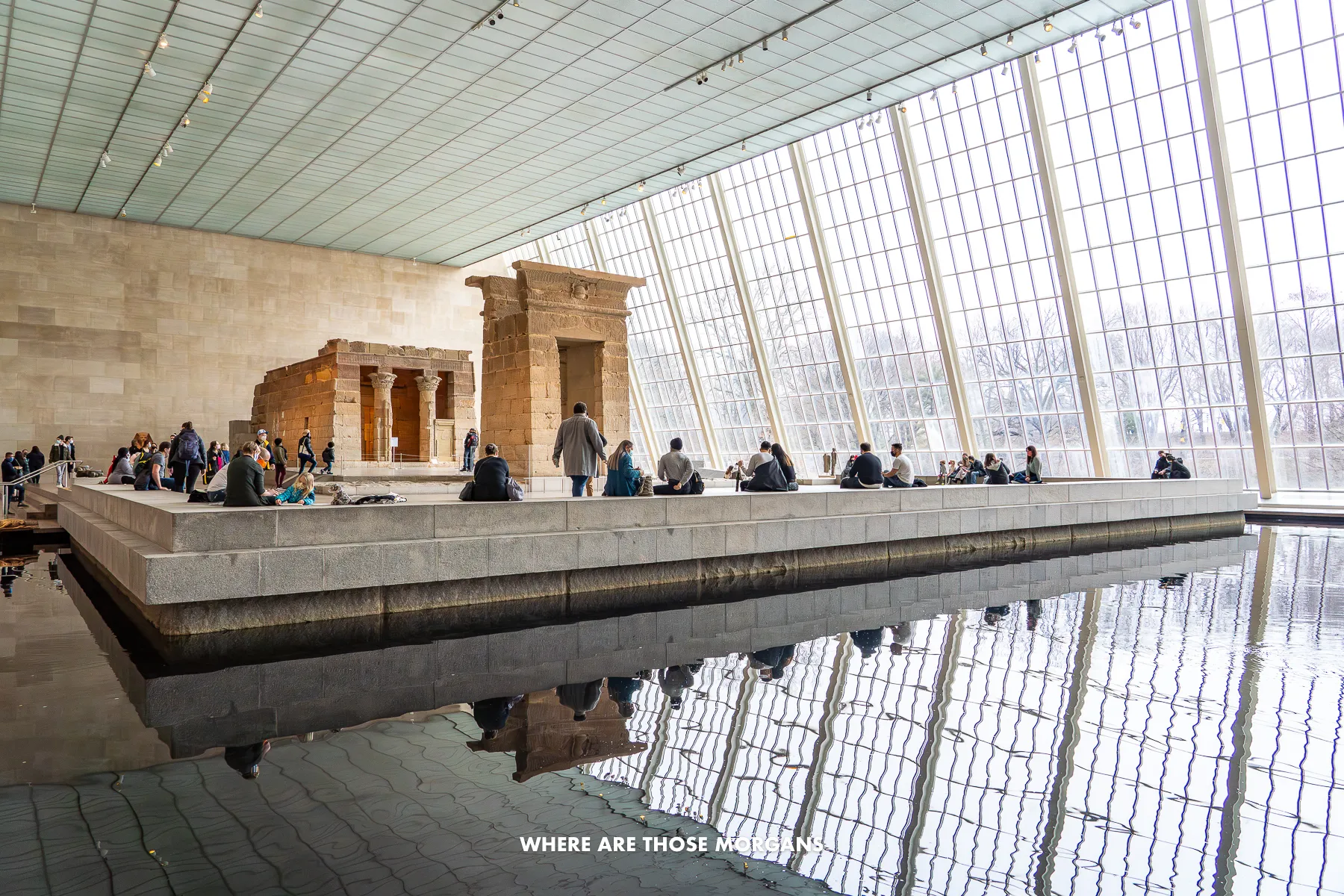 Inside the Egyptian section of the MET museum in NYC with water reflecting light from massive windows
