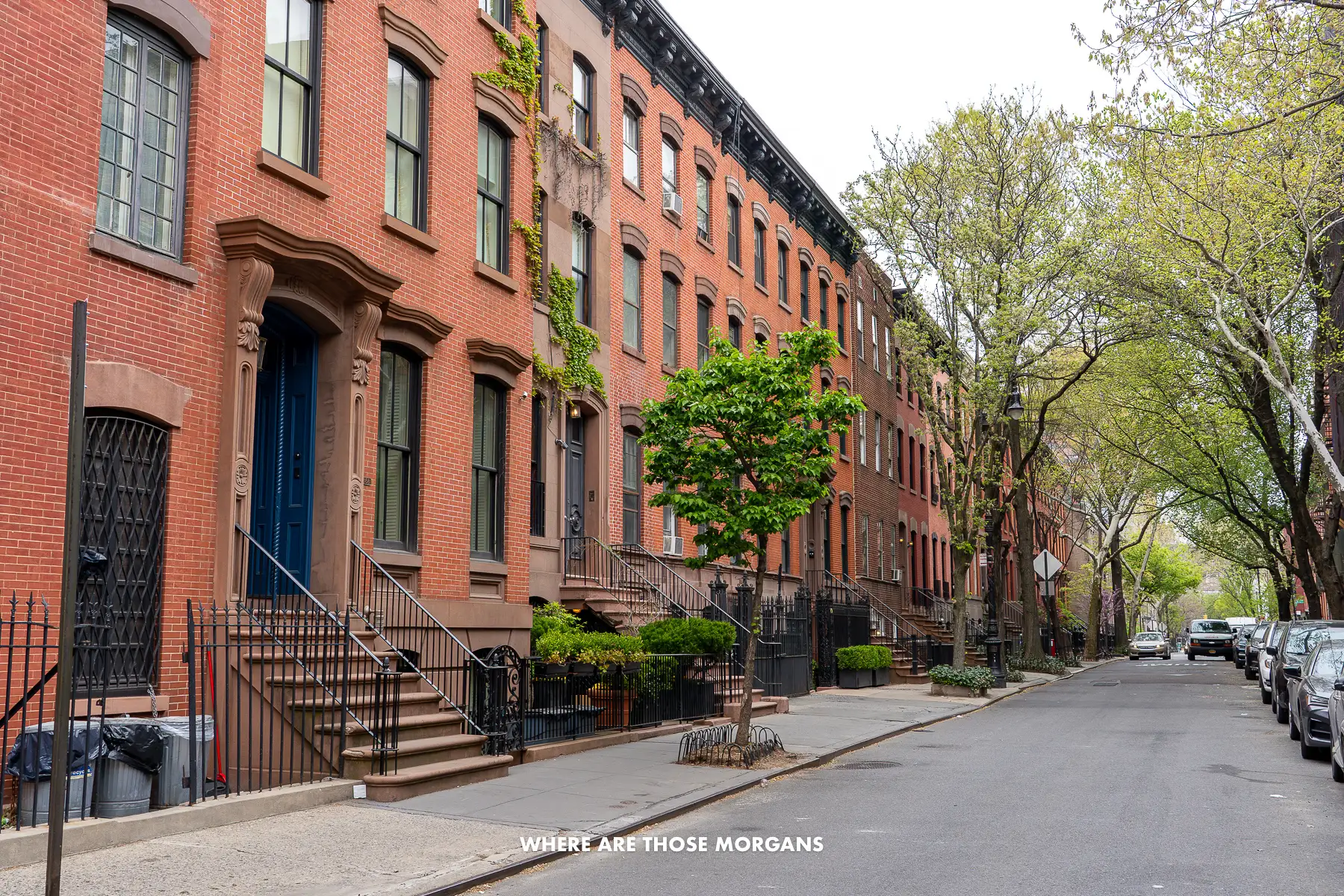 Row of brownstone houses and brick townhomes in a quiet residential street in Greenwich Village New York