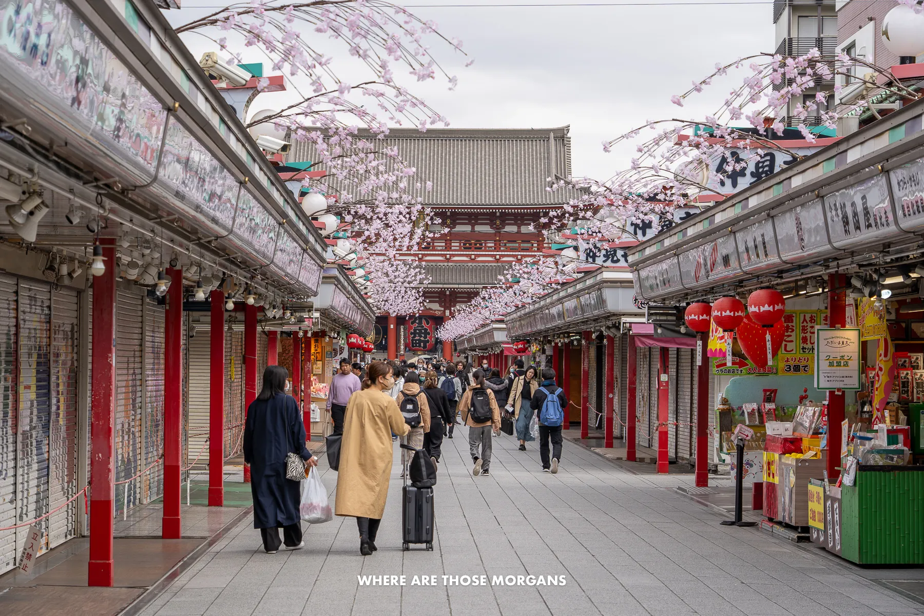 Quiet narrow shopping street leading to a temple early in the morning with just a few other people around
