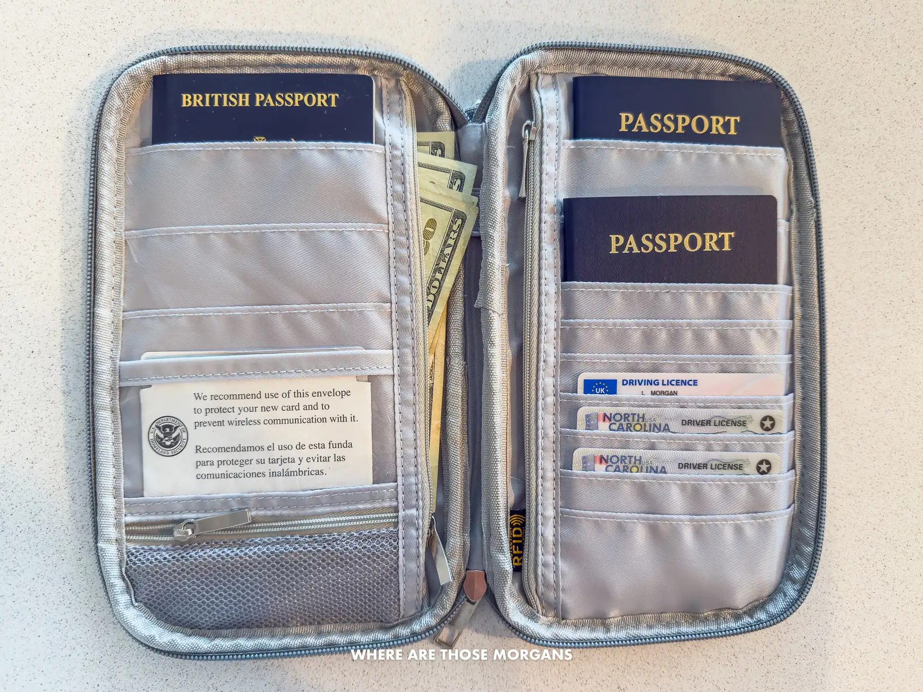 Photo of an opened passport holder with passports inside along with money and driving licenses
