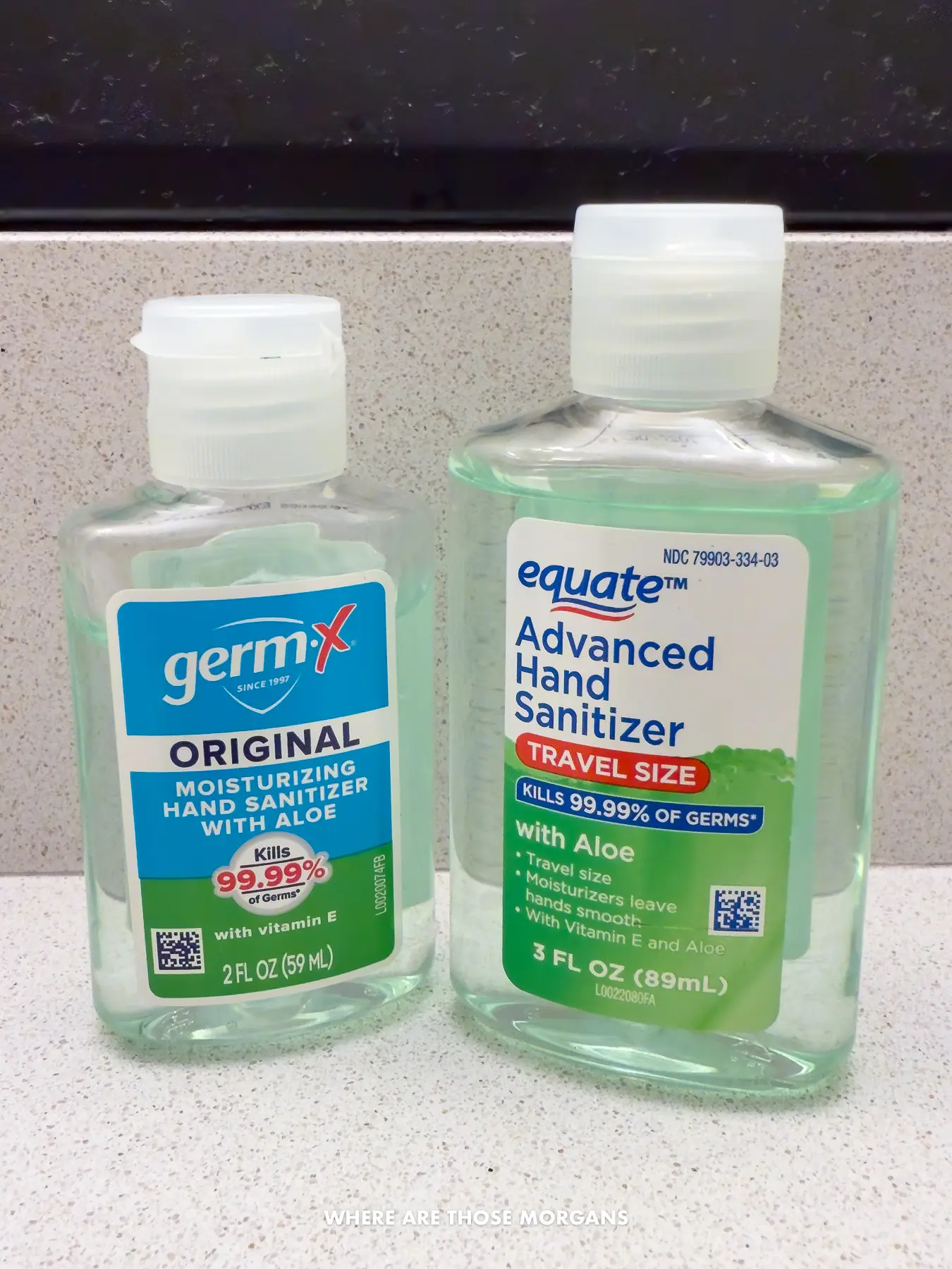 Two small hand sanitizer bottles on a bathroom counter