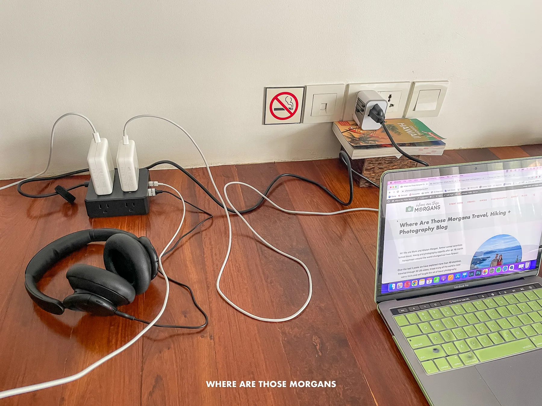 Photo of a laptop and headphones plugged into an extension cord on a table