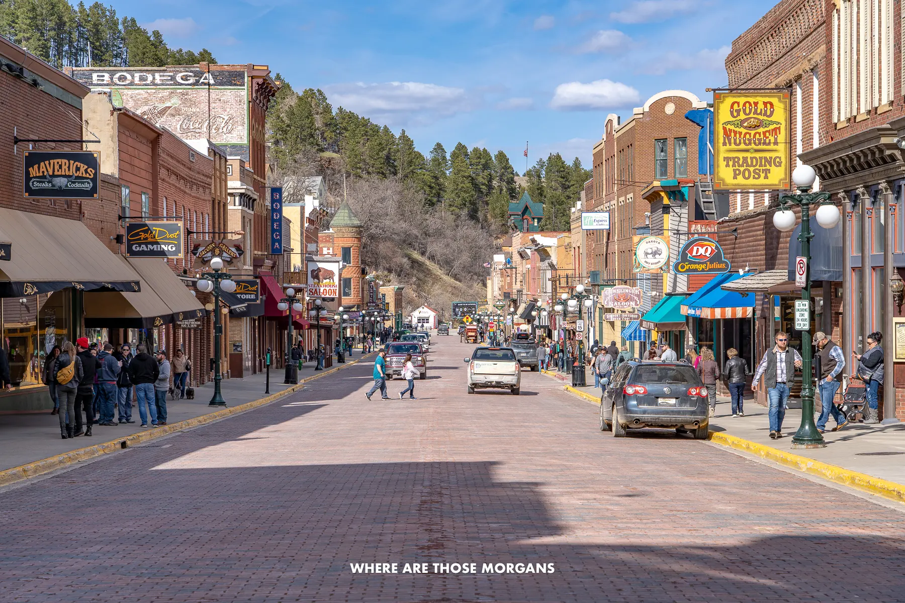 Looking up the historic main street in Deadwood SD with cars and people walking around