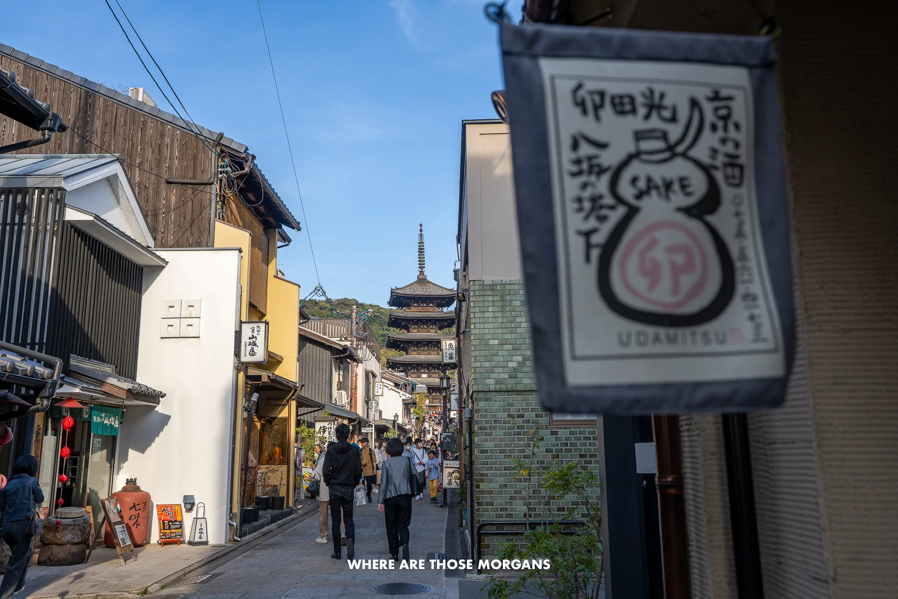 Narrow street in Higashiyama Kyoto with tourists and locals walking