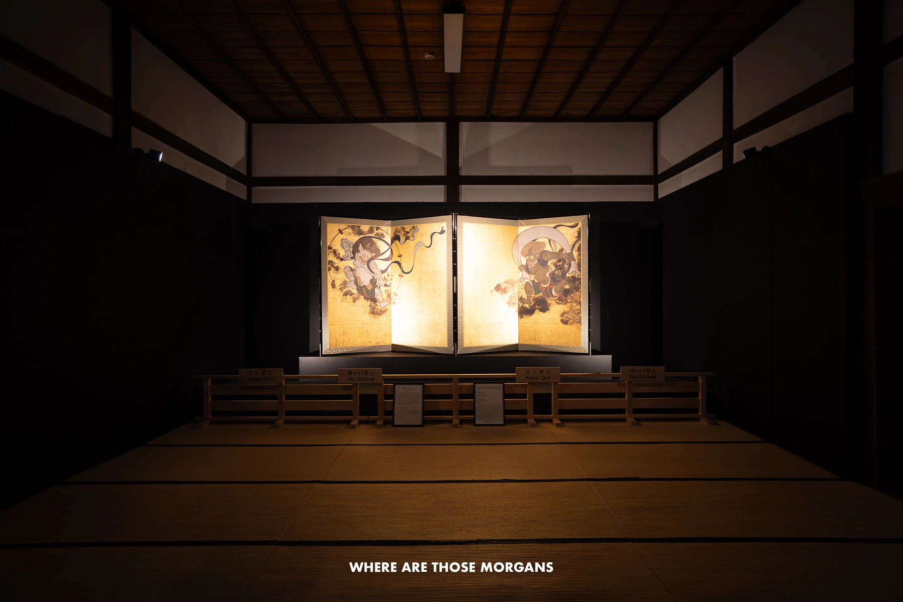 The Wind God and Thunder God screen lit up in a dark room at Kennin-ji Temple