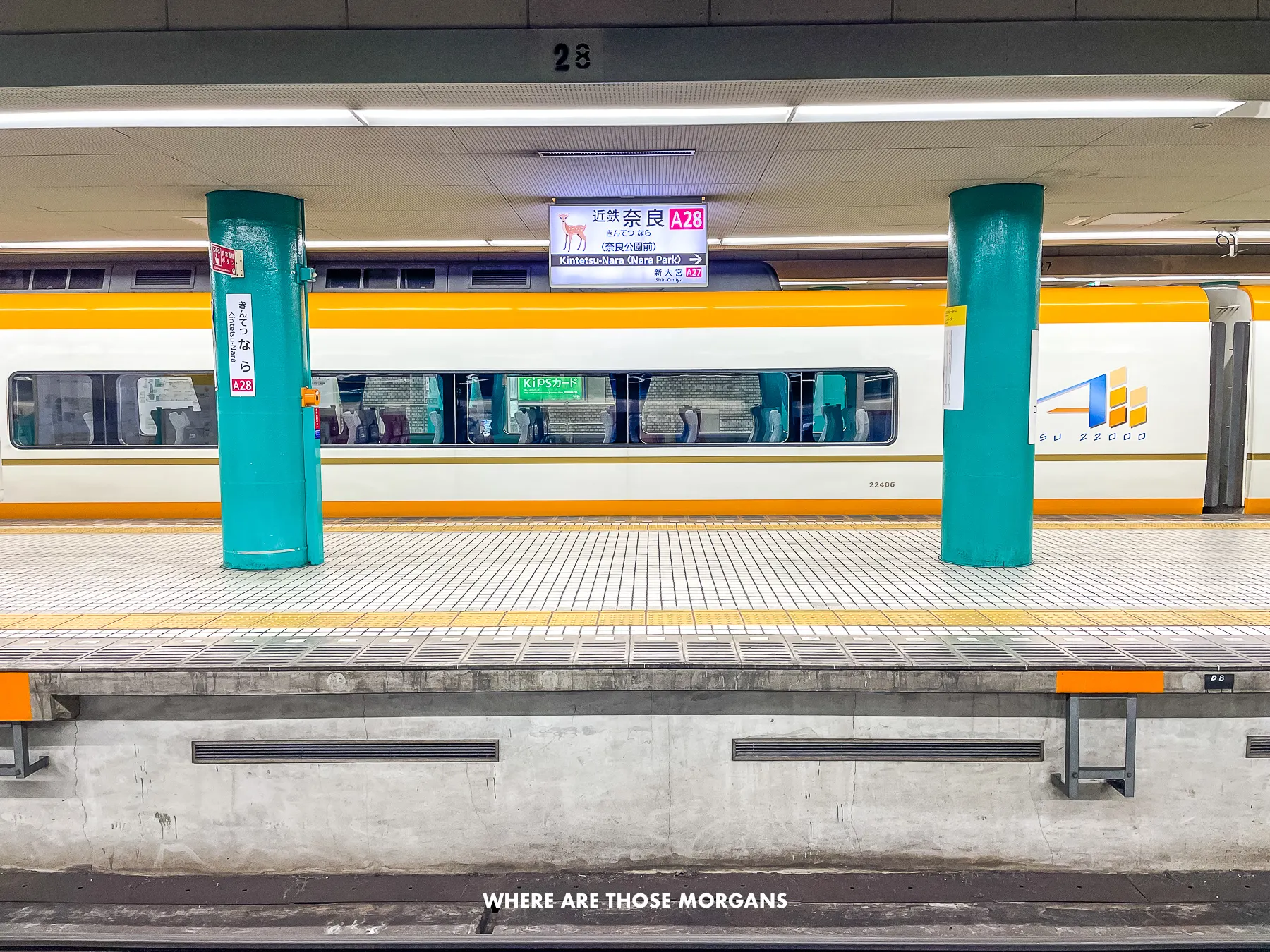 A train stopped at a platform in Nara Kintetsu station
