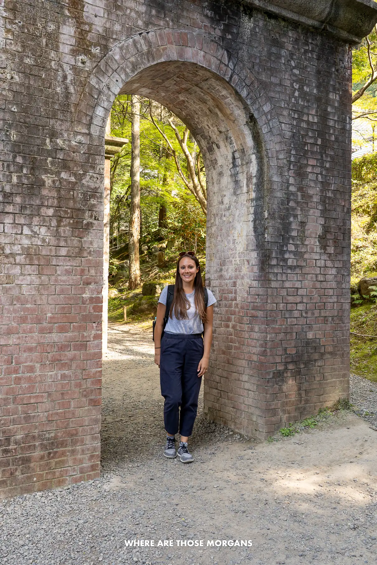 Kristen from Where Are Those Morgans standing underneath an arch of a brick aqueduct