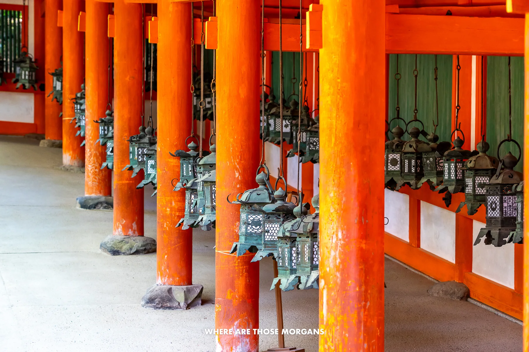 Shrine with vermilion red columns and hanging lanterns in Nara Japan