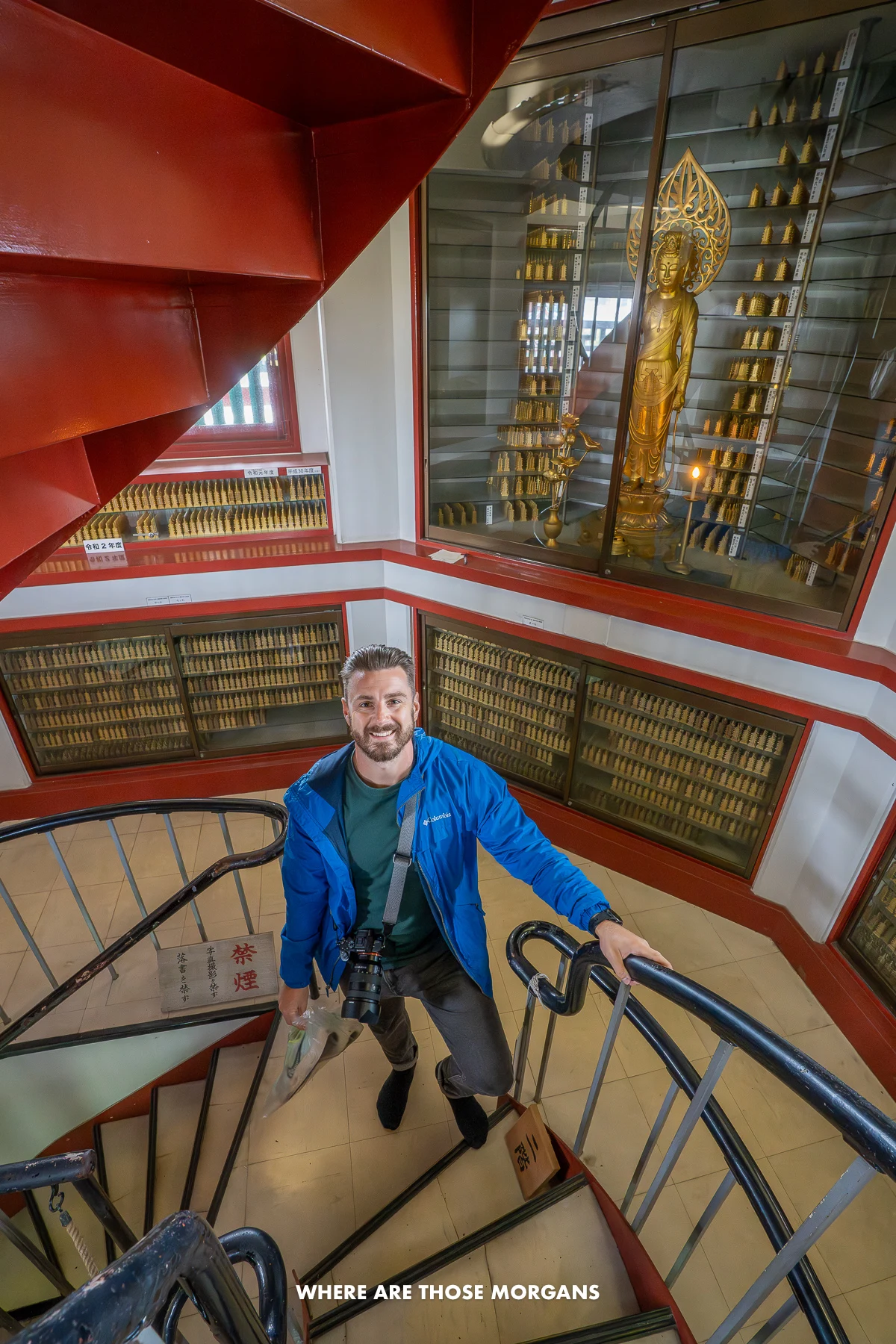 Mark from Where Are Those Morgans walking up a spiral staircase inside a pagoda in Japan