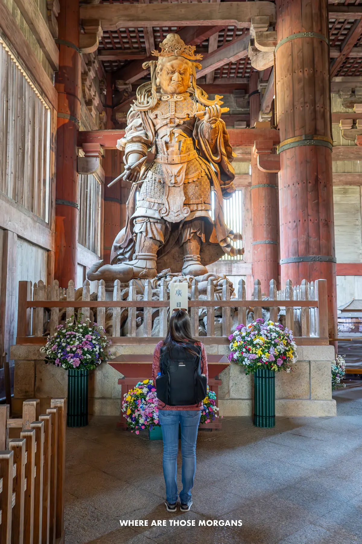 Kristen from Where Are Those Morgans looking up at a massive statue inside Todai-ji Temple in Nara