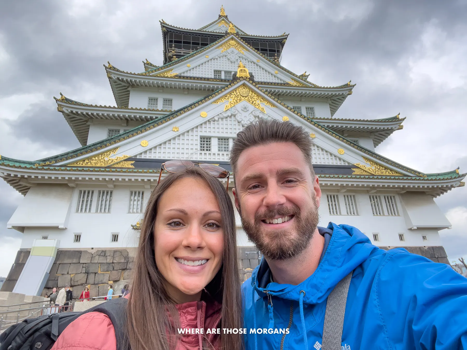 Mark and Kristen from Where Are Those Morgans taking a selfie in front of Osaka Castle on a cloudy day