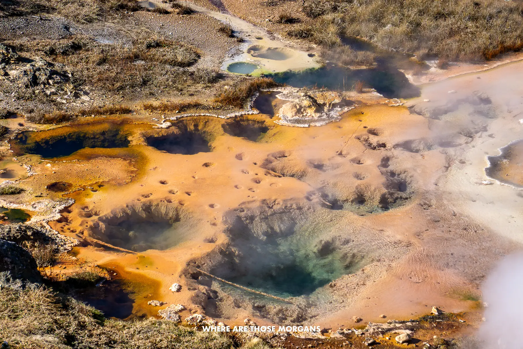 Orange colored hot spring and geysers that looks a bit like an artists palette