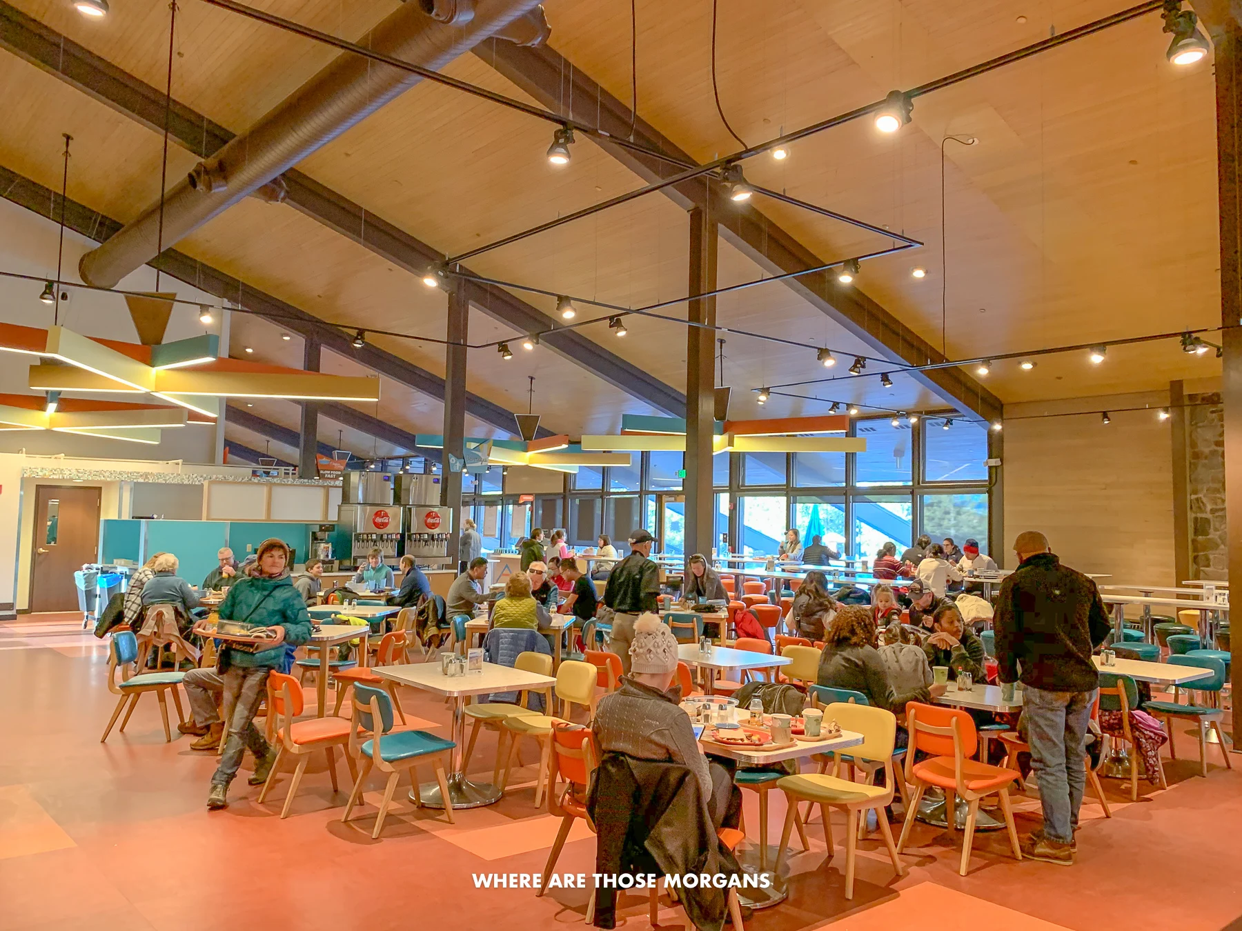 Inside the Canyon Lodge dining room at Yellowstone with tourists sat at tables eating food