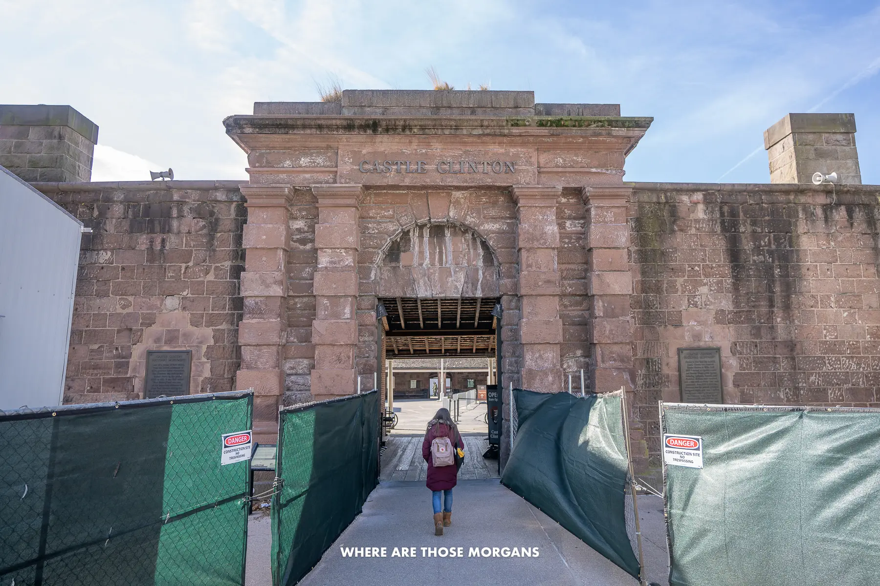 Kristen from Where Are Those Morgans walking into Castle Clinton with scaffolding on either side