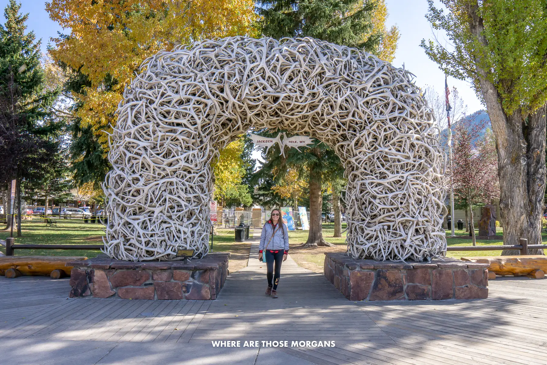 Kristen from Where Are Those Morgans standing underneath the Jackson Town Square antler arch in Wyoming