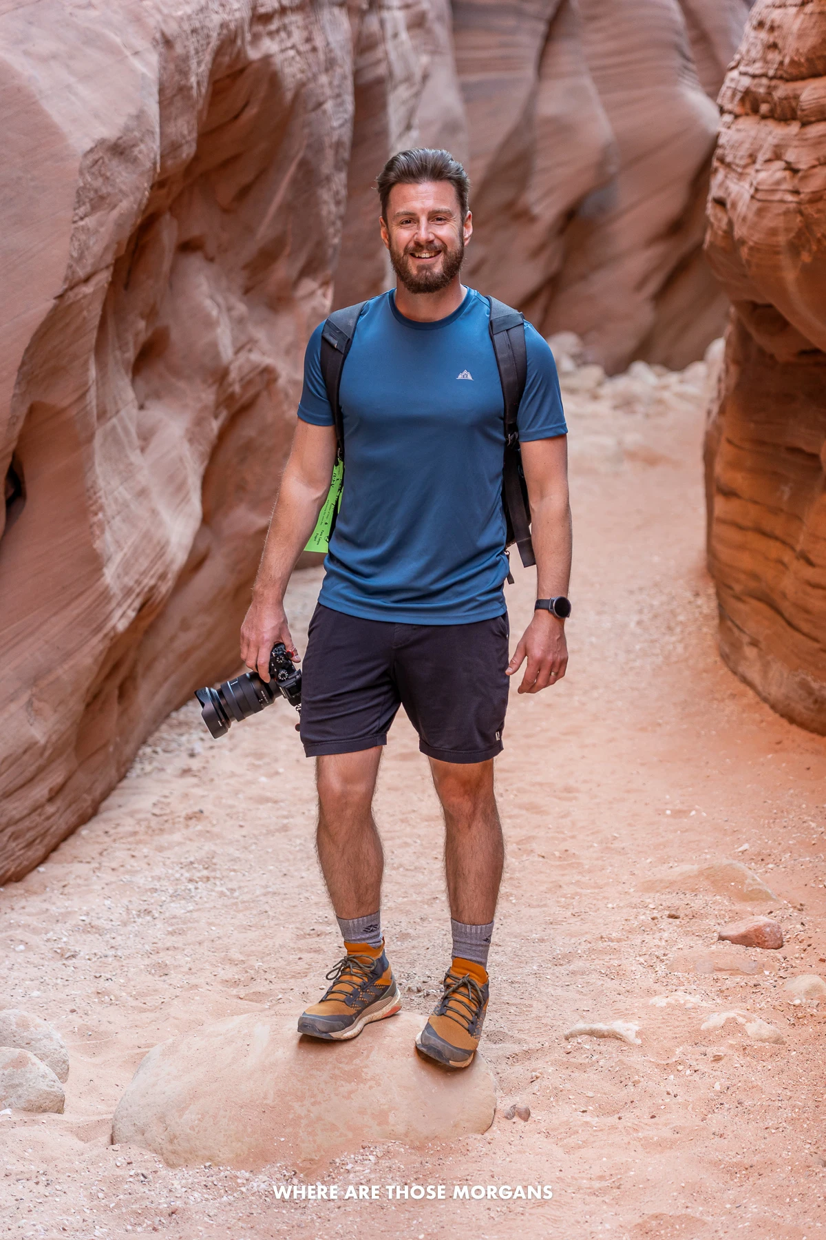 Mark from Where Are Those Morgans stood inside the narrow Buckskin Gulch slot canyon holding a camera