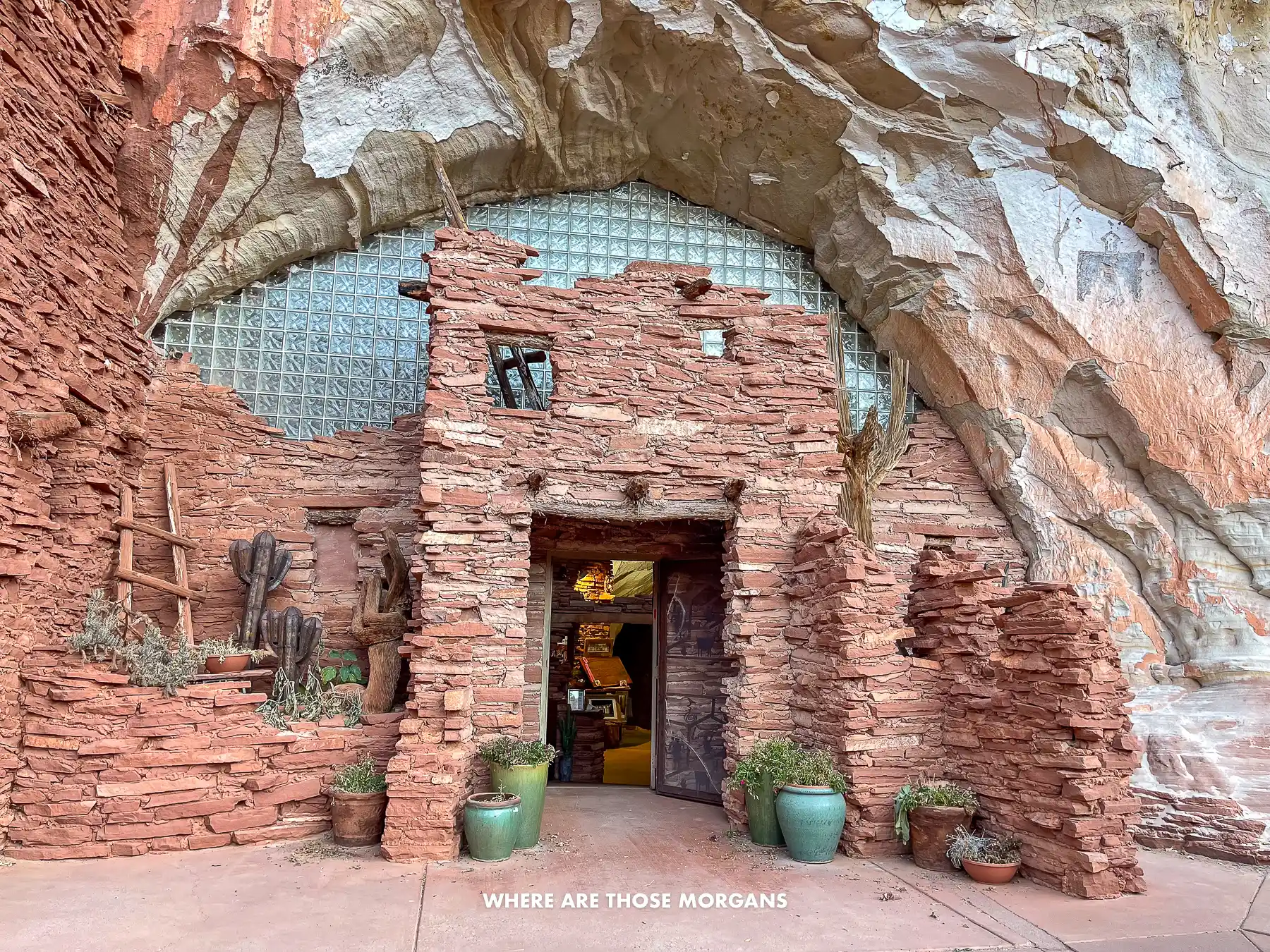 The entrance to Moqui Cave Museum in Kanab with stone and glass built into an old cave opening