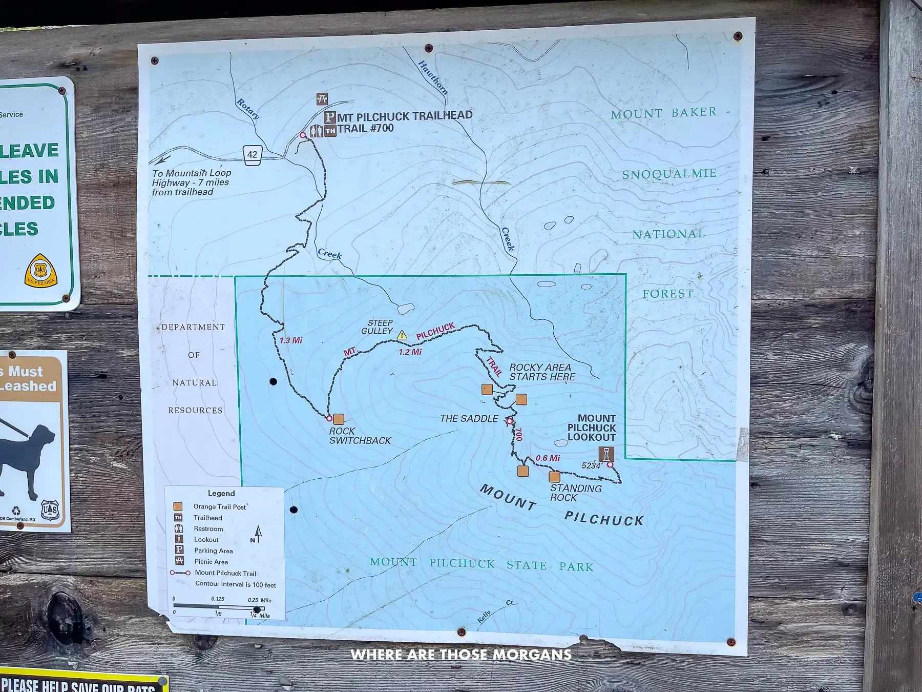 Trail map on a wooden board at the beginning of a hike in Washington State