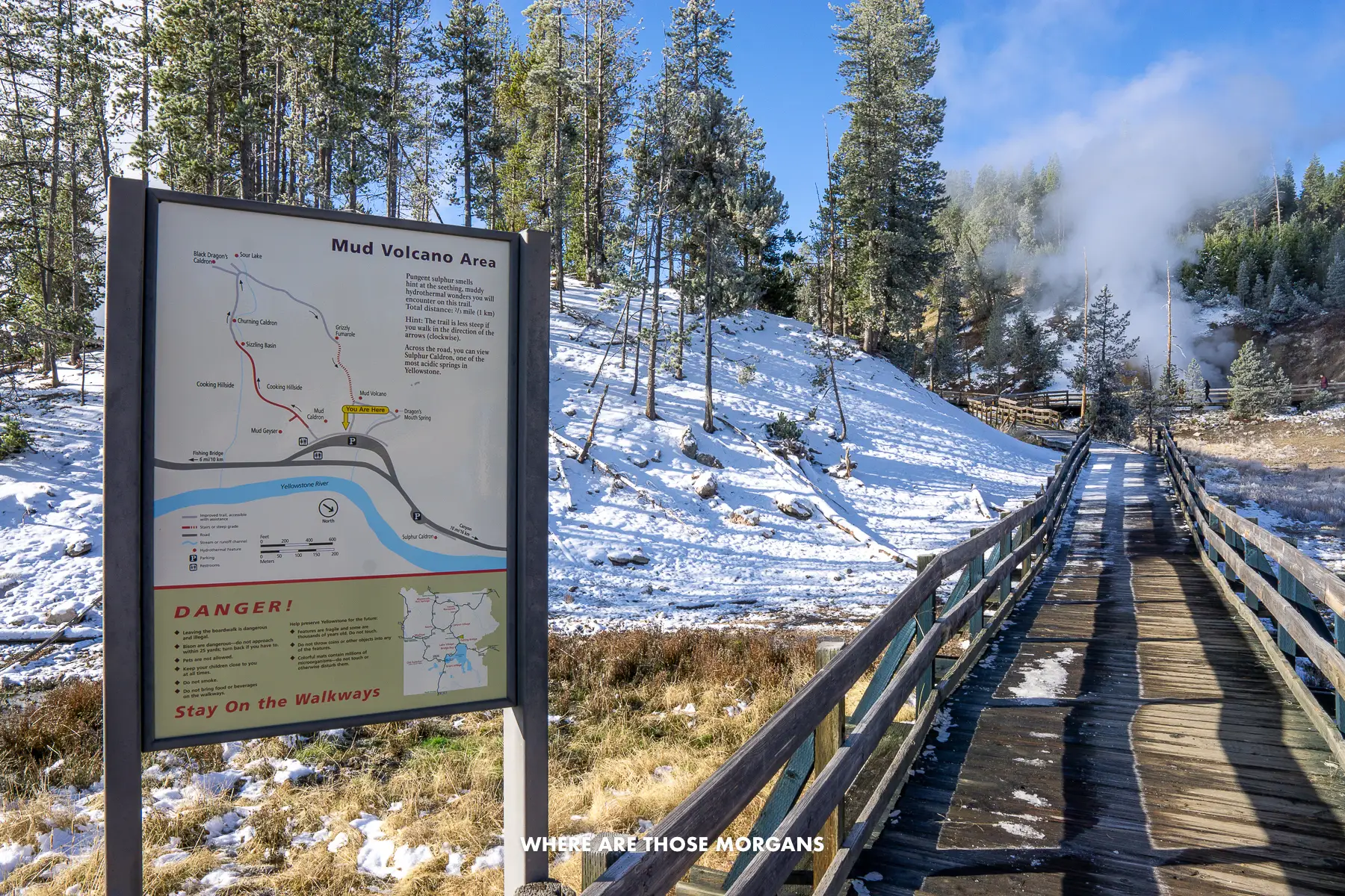 Wooden boardwalk with a sign for a Yellowstone region called Mud Volcano