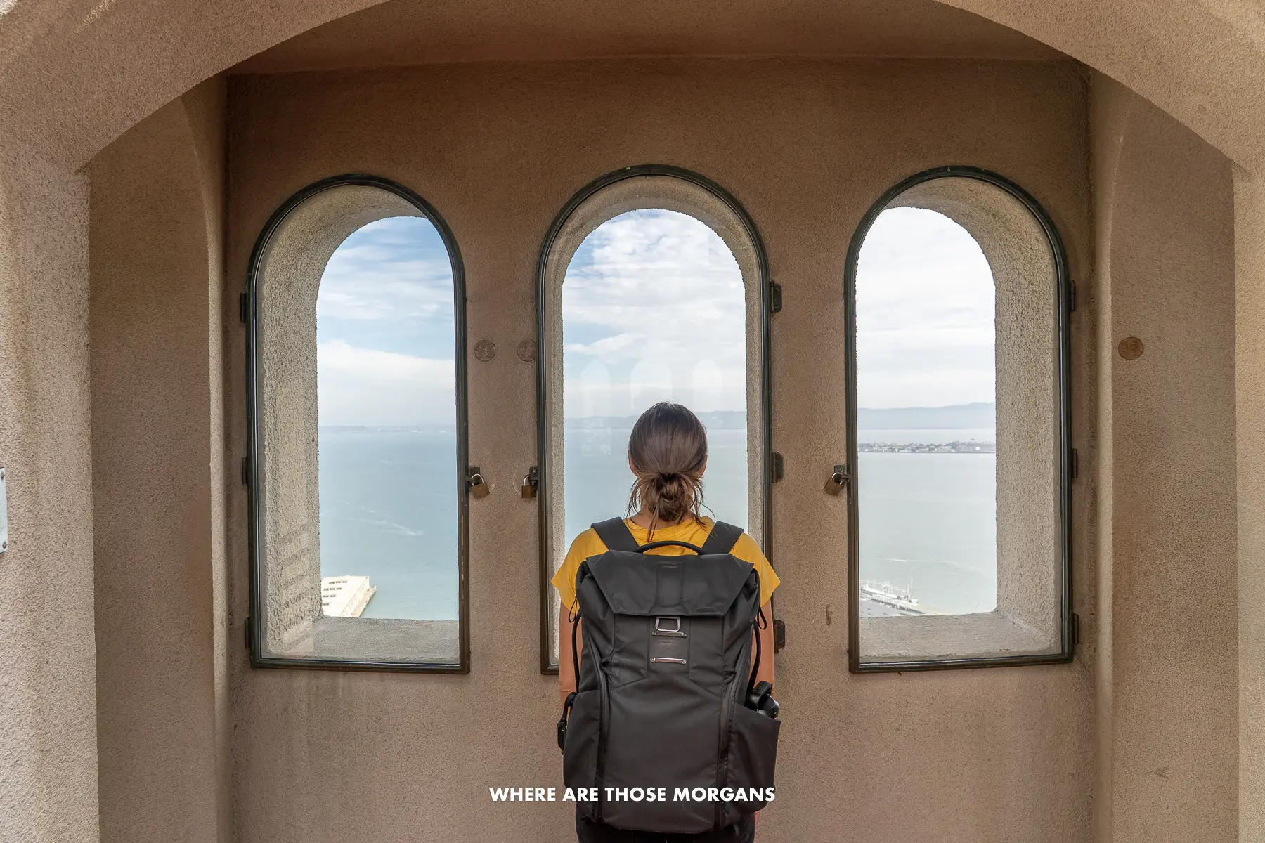 Kristen from Where Are Those Morgans looking out of three windows at the top of Coit Tower