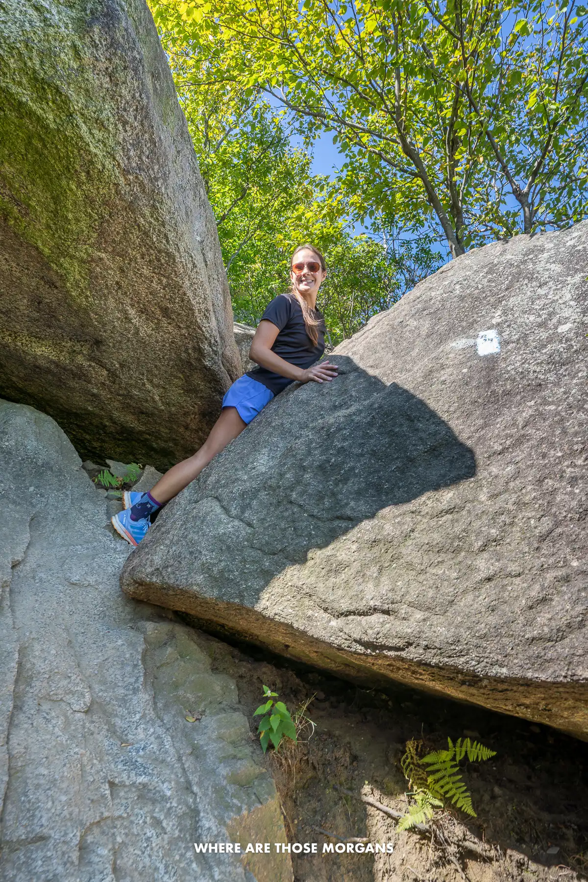 Kristen from Where Are Those Morgans climbing over boulders on the Old Rag hike