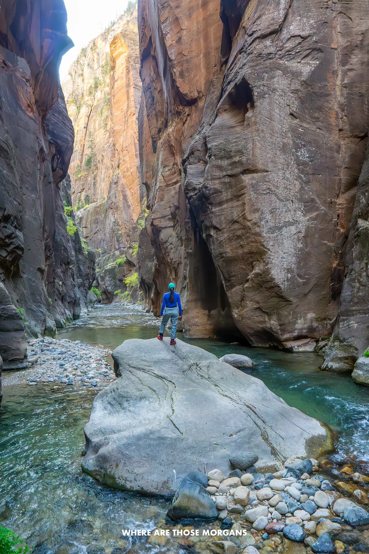 Kristen from Where Are Those Morgans standing on a rock in the middle of The Narrows slot canyon