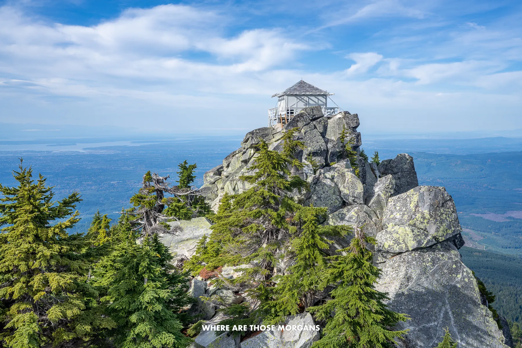 White fire lookout tower perched at the top of Mt Pilchuck in Washington