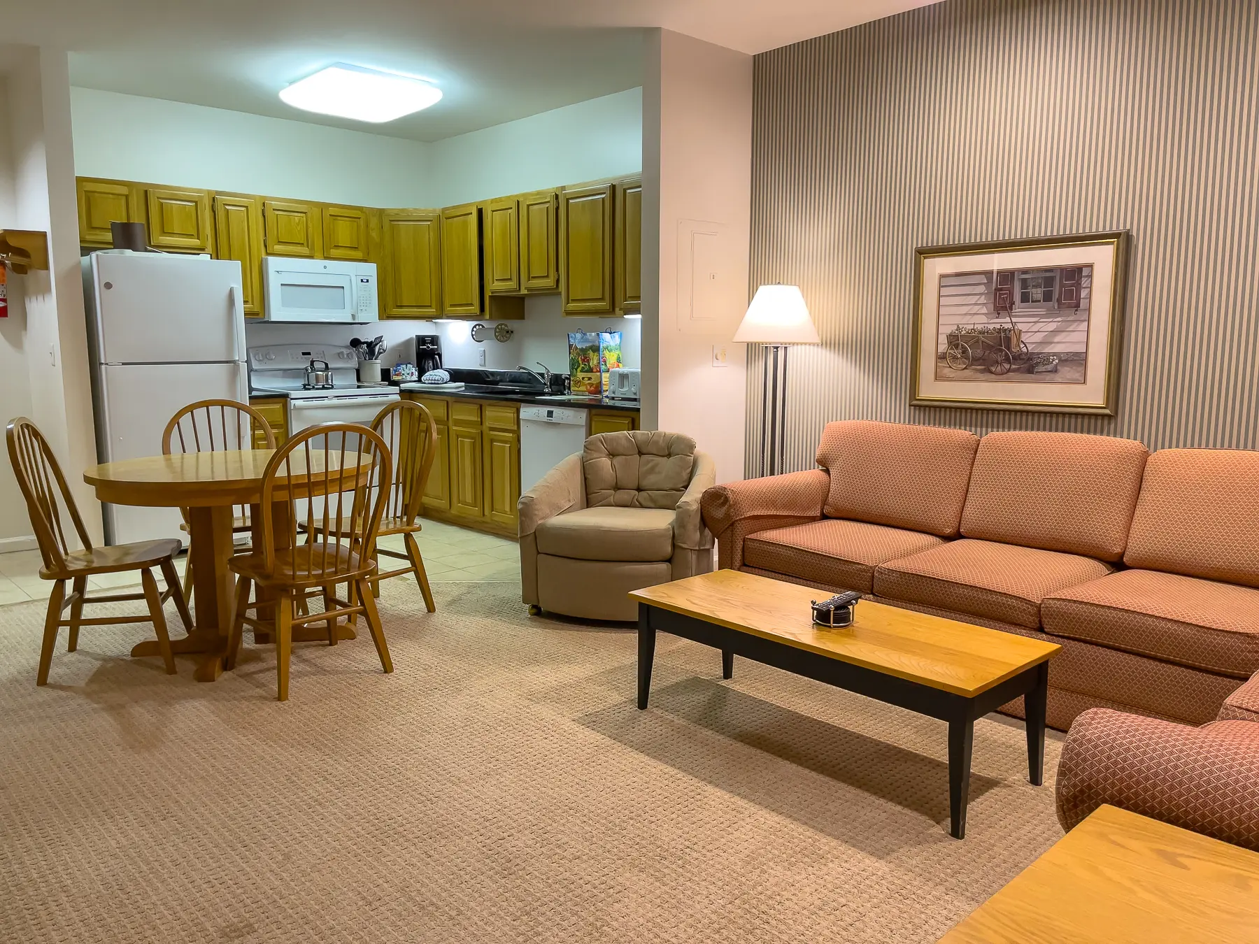 Photo of the inside of a condo in Smugglers Notch Vermont with a sofa, table and chairs, and kitchen