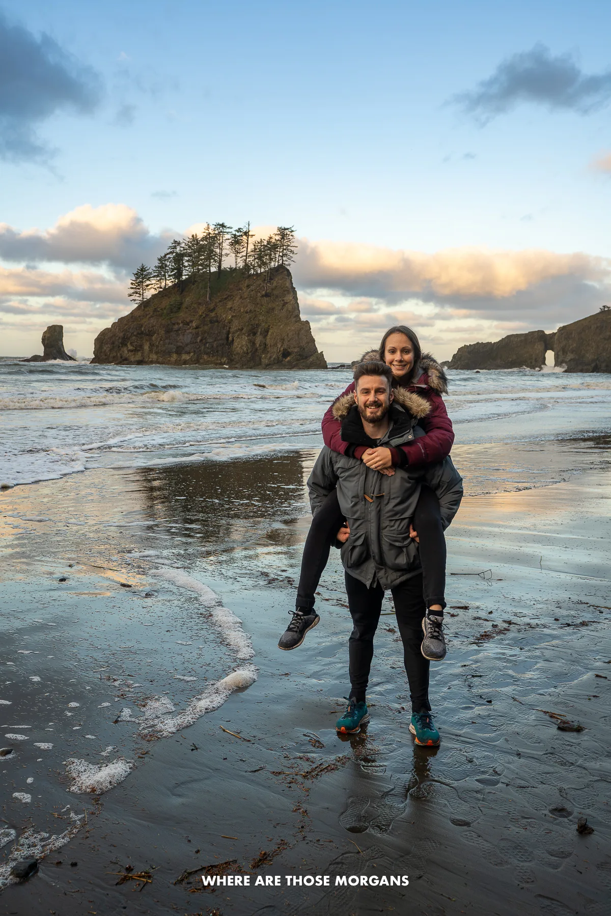 Mark and Kristen from Where Are Those Morgans standing alone on a beach in Washington next to the water line at dawn