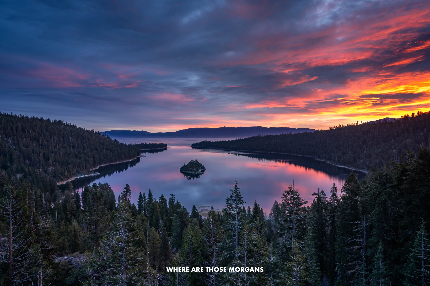 Colorful clouds glowing the sky at sunrise over Emerald Bay in Lake Tahoe