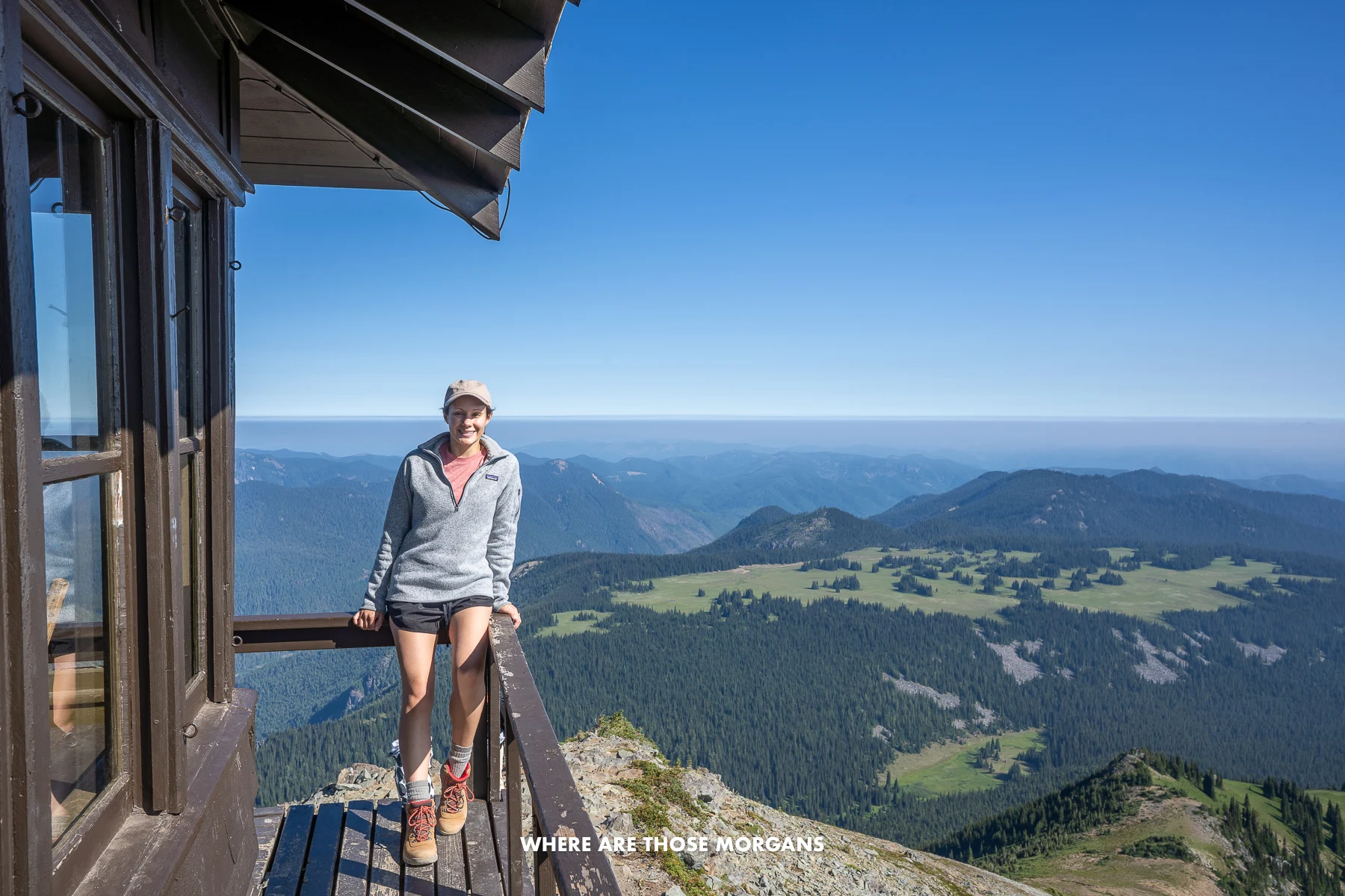 Kristen from Where Are Those Morgans enjoying wide open far reaching views from a fire lookout tower in Mt Rainier National Park