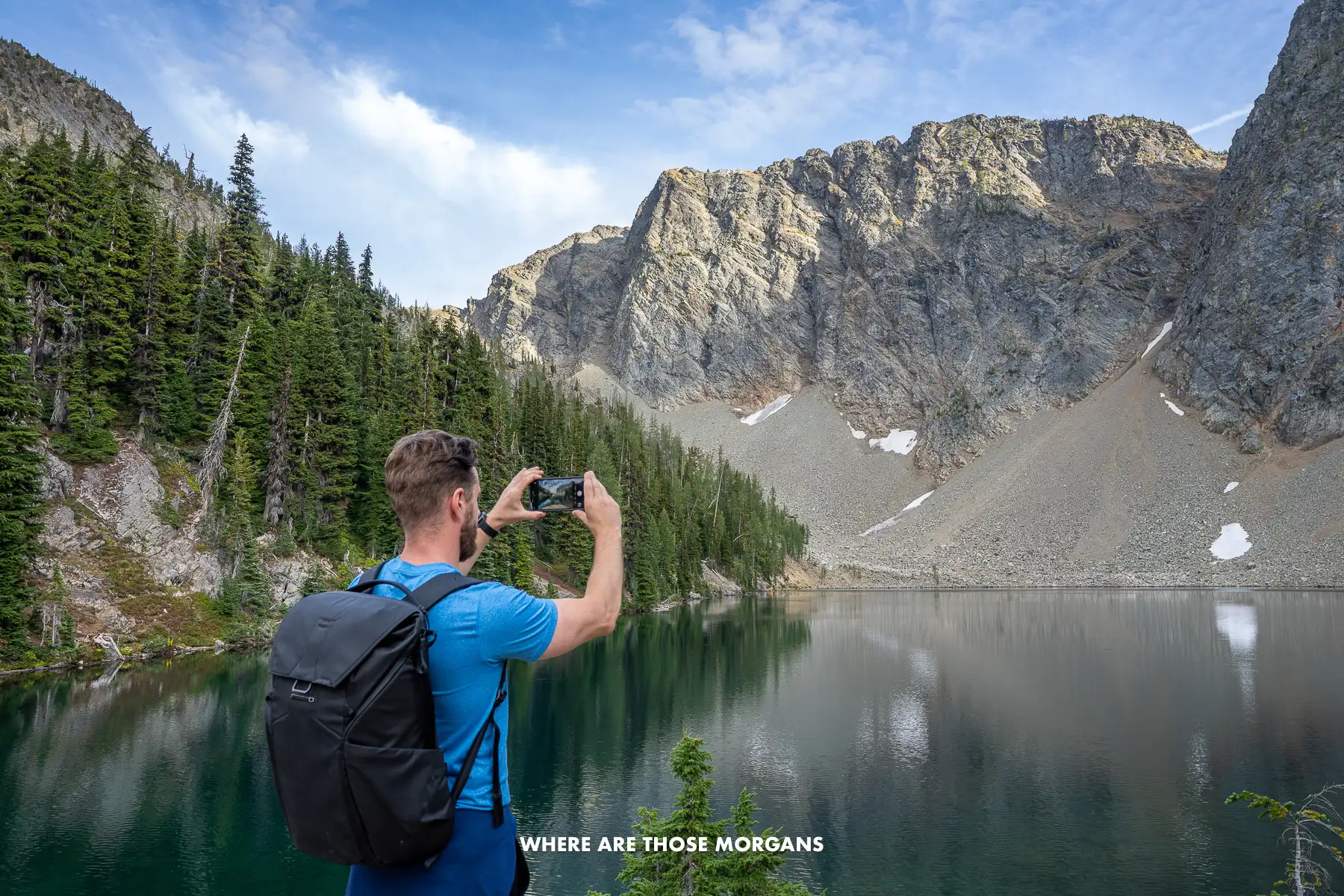 Mark from Where Are Those Morgans taking a photo with a phone of a lake in Washington