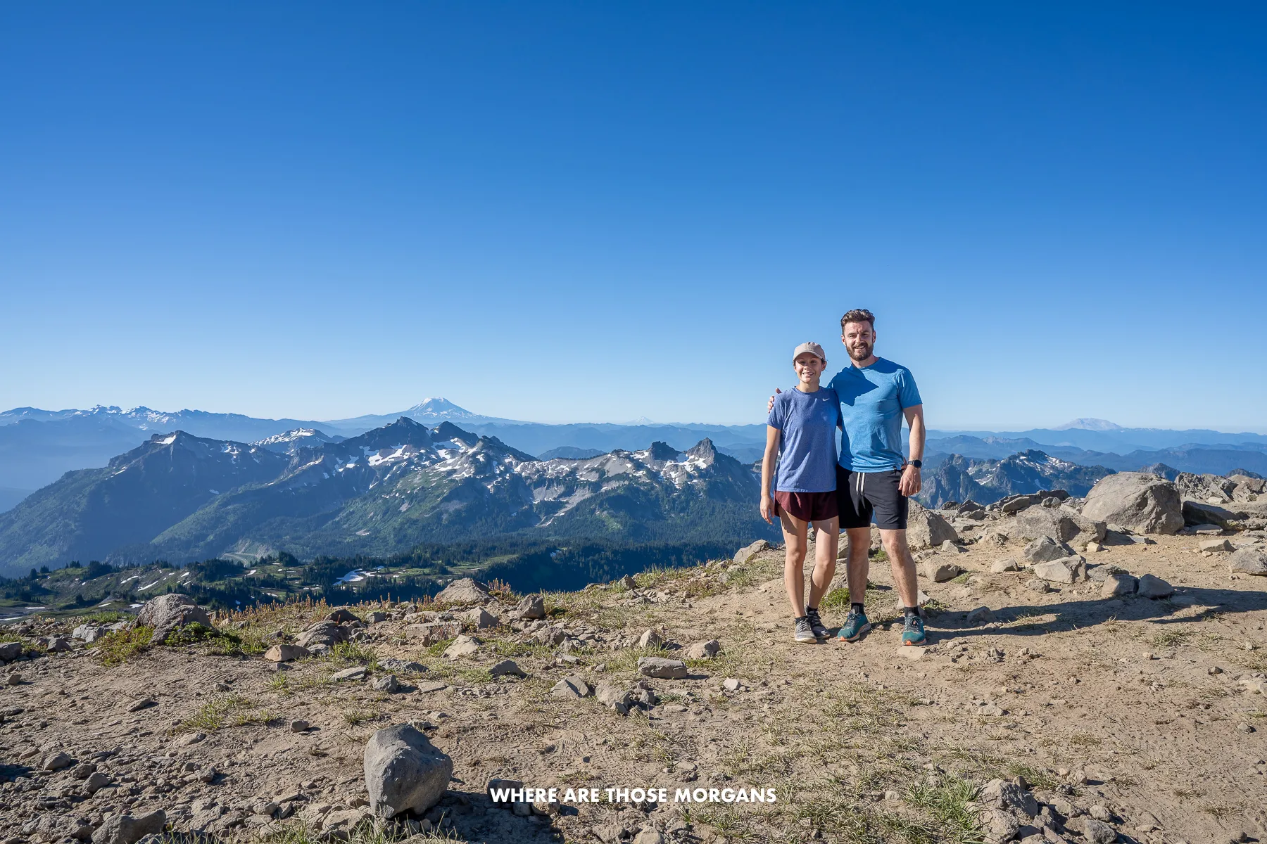 Mark and Kristen from Where Are Those Morgans posing for a photo at the summit of a hike in Mt Rainier National Park in Washington State, USA
