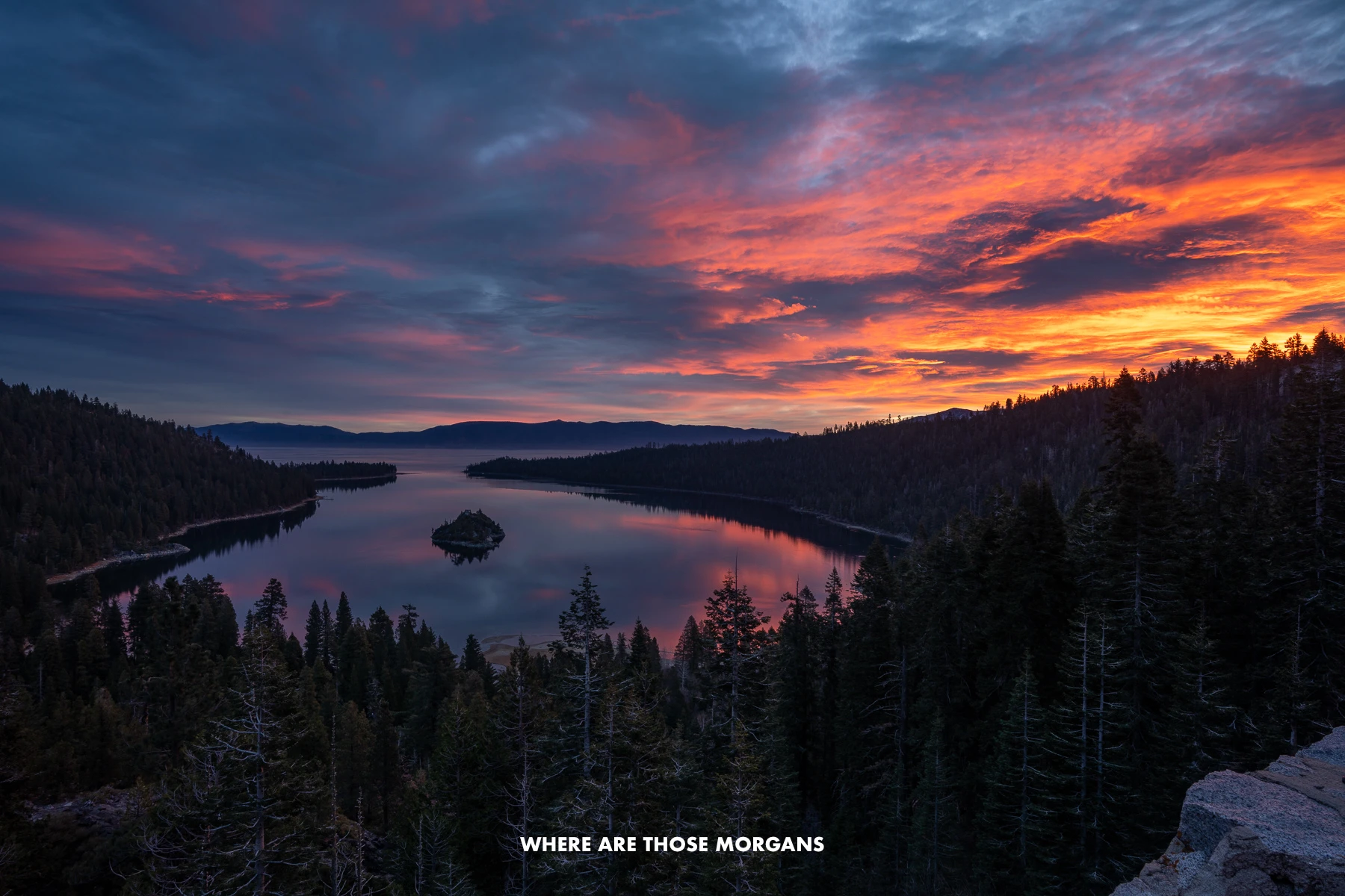 Emerald Bay sunrise in Lake Tahoe with reds, pinks and blues in the clouds