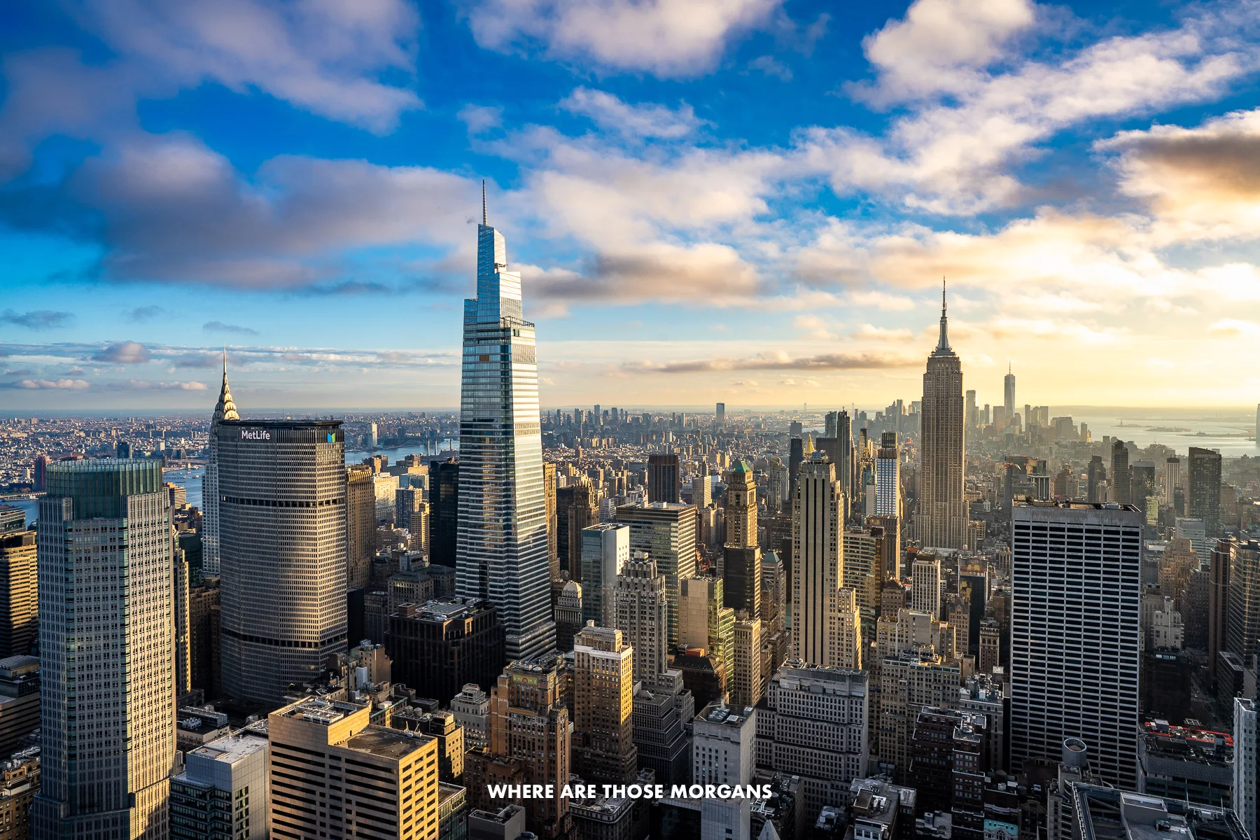 The New York City skyline from Top of the Rock not long before sunset with cotton wool clouds in the sky