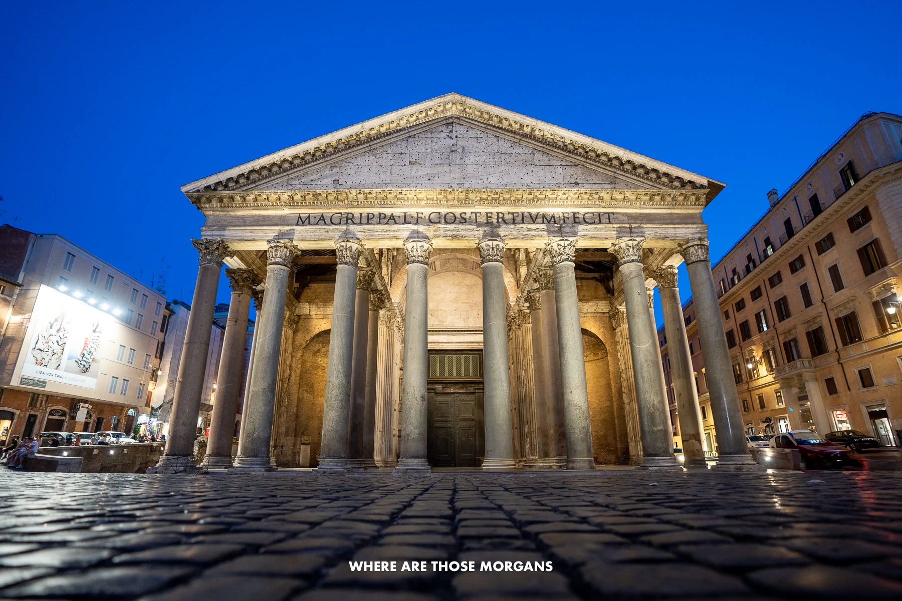 Pantheon in Rome lit up at night with cobbled square in front