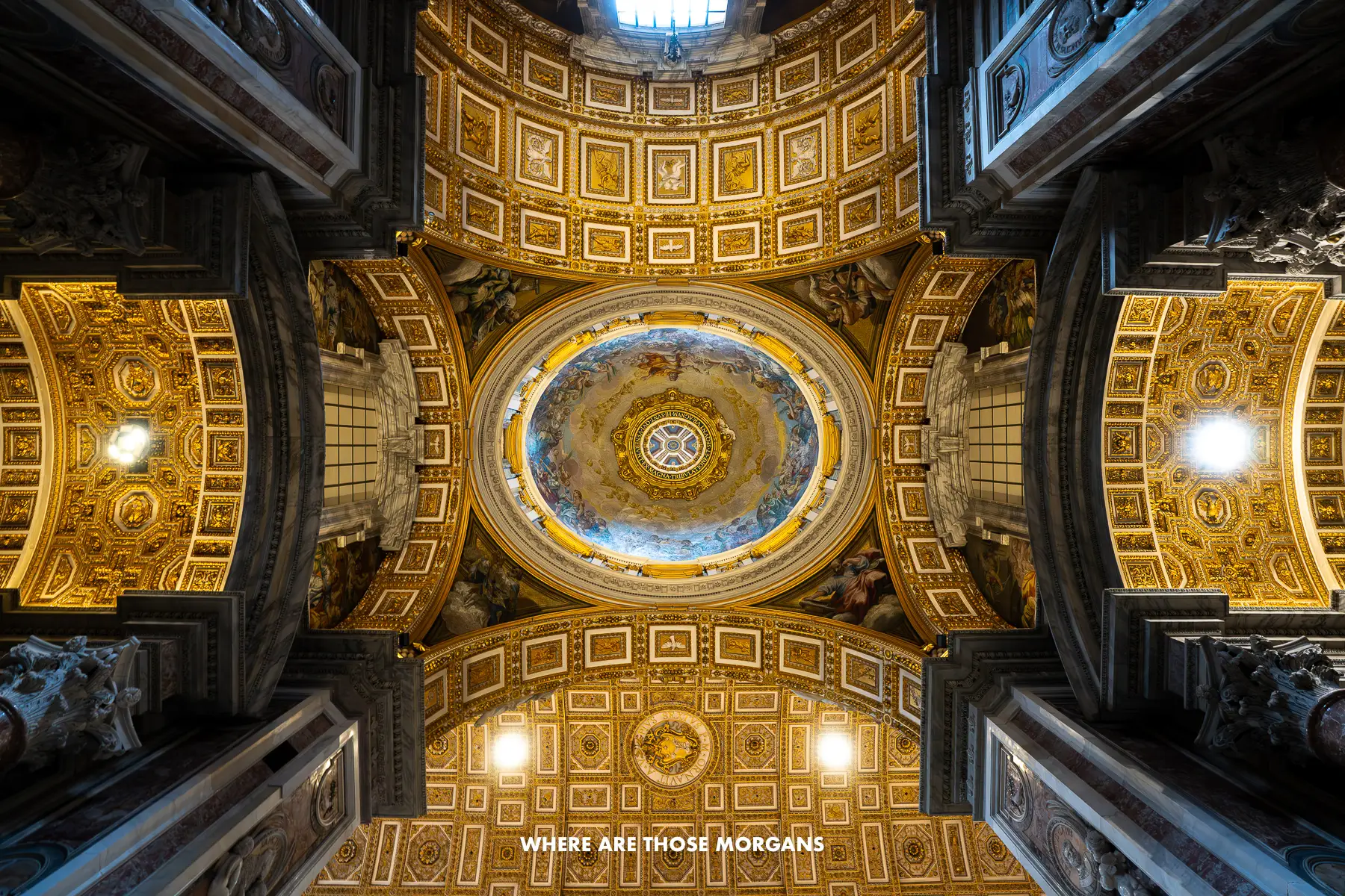 Photo looking up at the ceiling design of St Peters Basilica from directly below
