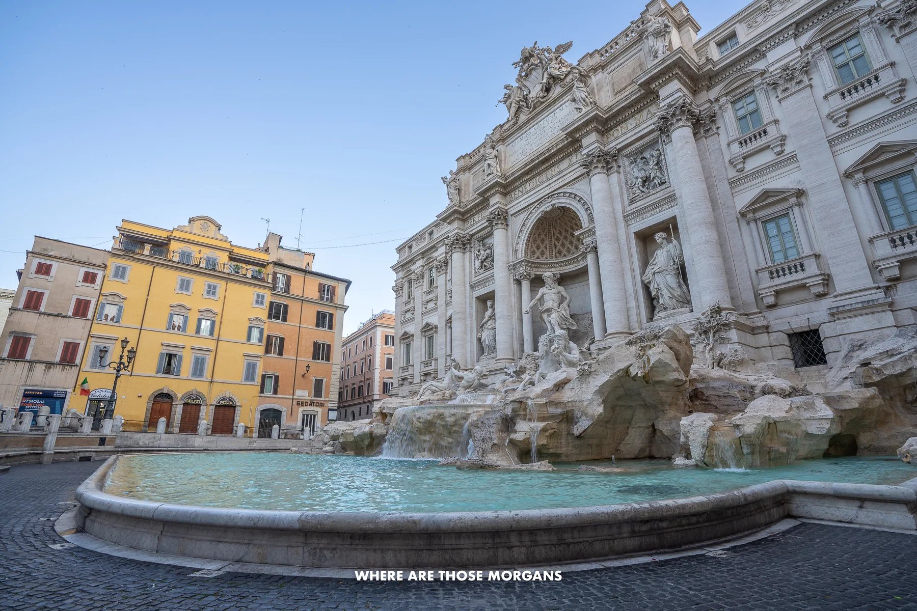 The Trevi Fountain from a side profile at dawn with no people