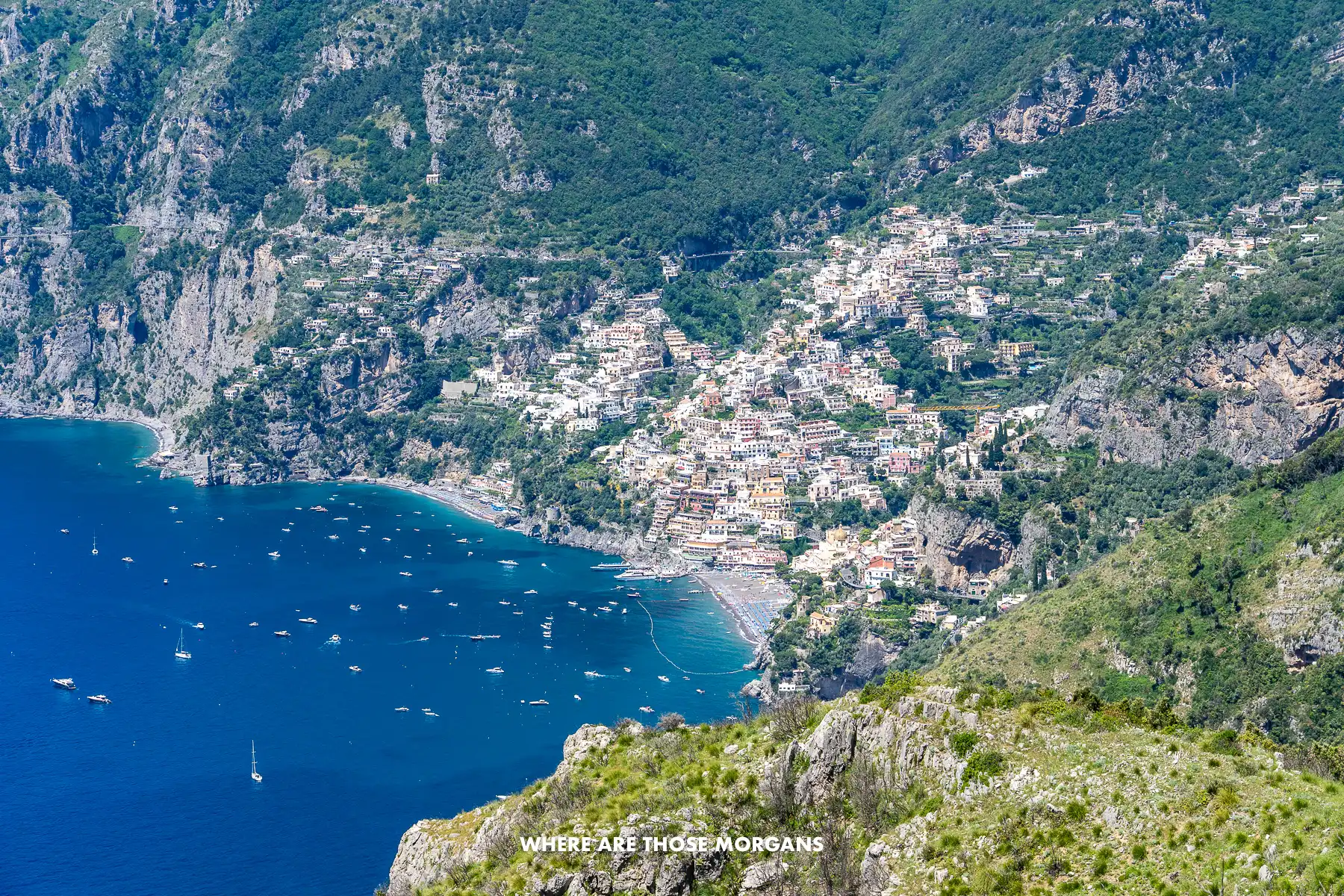 Photo taken from high up on Path of the Gods hike at the top of the cliffs looking down on the coastal town of Positano in the distance