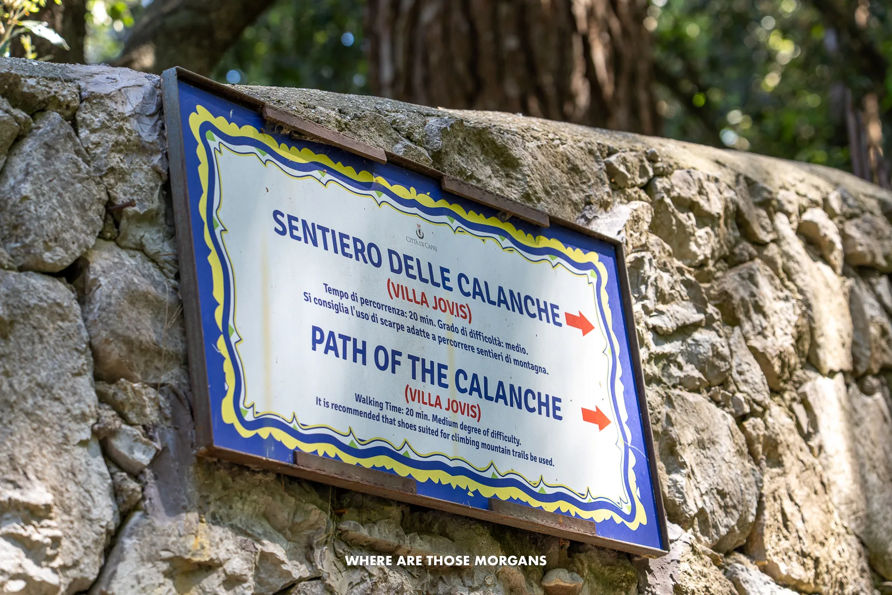 Photo of a tiled street sign showing directions in Italy
