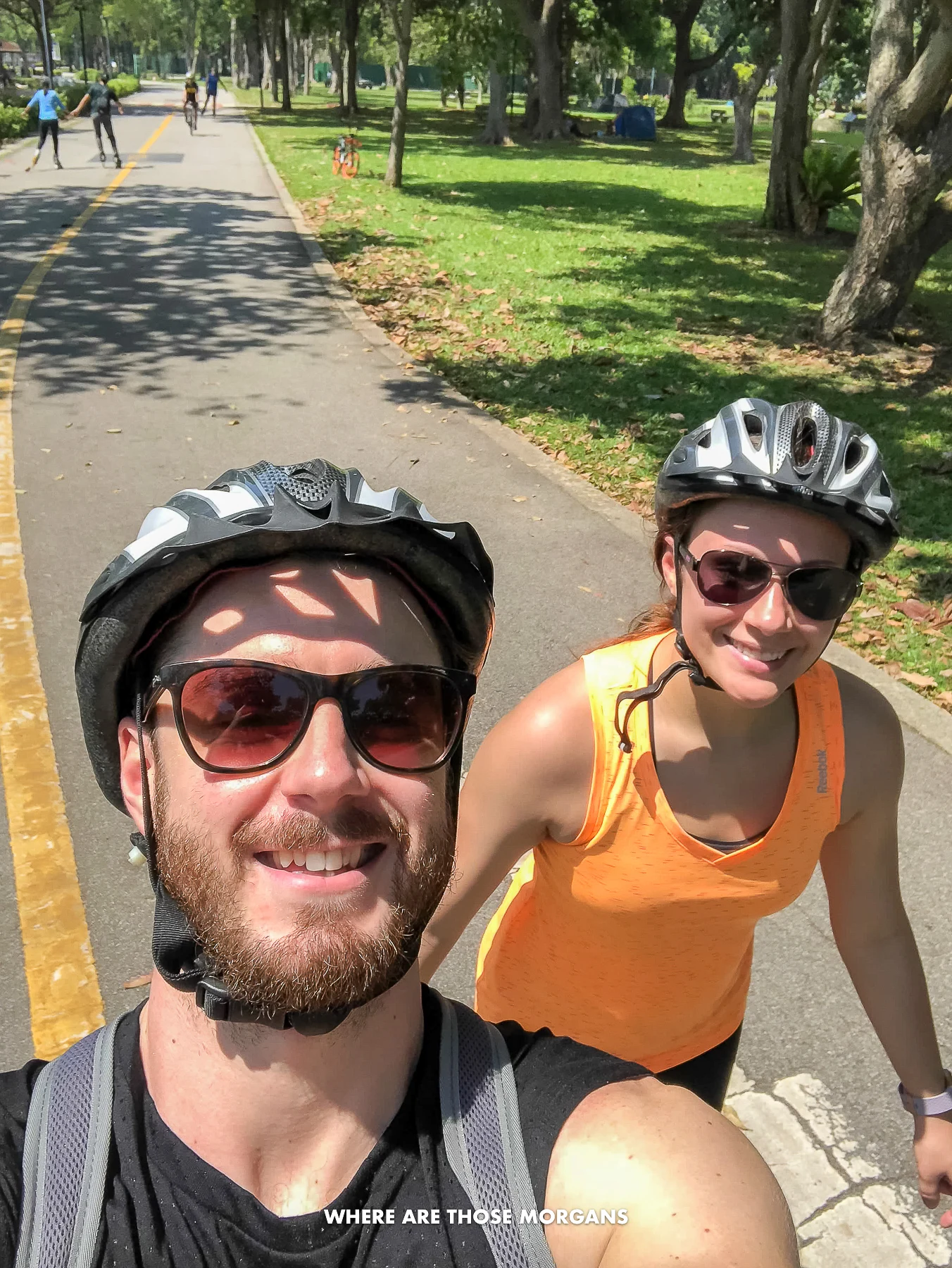 Mark and Kristen from Where Are Those Morgans taking a selfie rollerblading with helmets on in East Coast Park Singapore