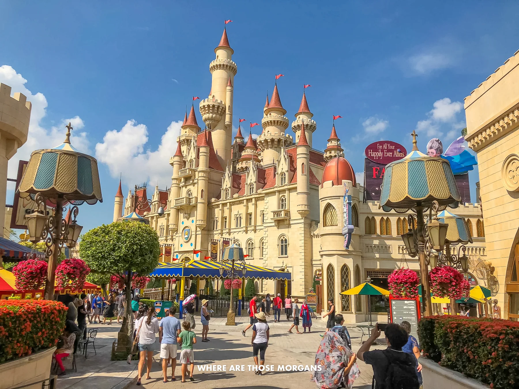 Tourists walking around Universal Studios with a castle facade and blue sky