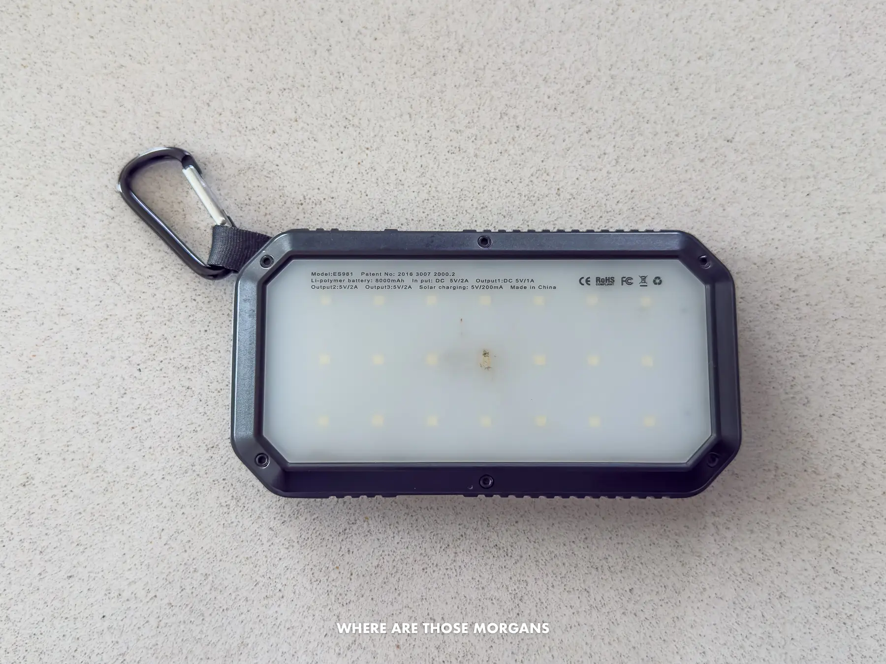 A travel sized solar-charged powerbank on a counter