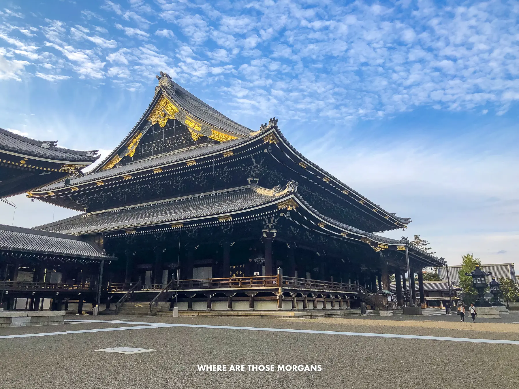 Large courtyard with a massive wooden building in Japan