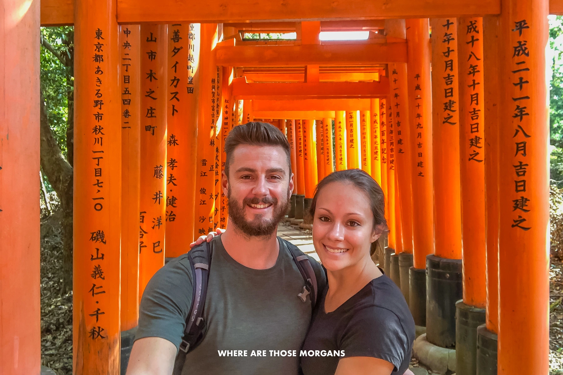 Mark and Kristen from Where Are Those Morgans taking a selfie with Fushimi Inari Shrine's vermilion red torii gates in Kyoto Japan