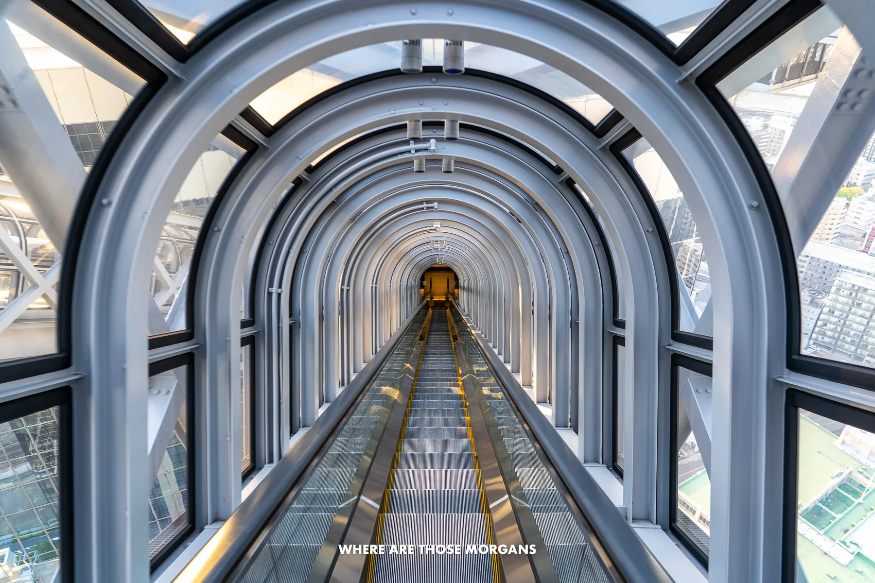 Tunnel like escalator between two tall towers in Osaka