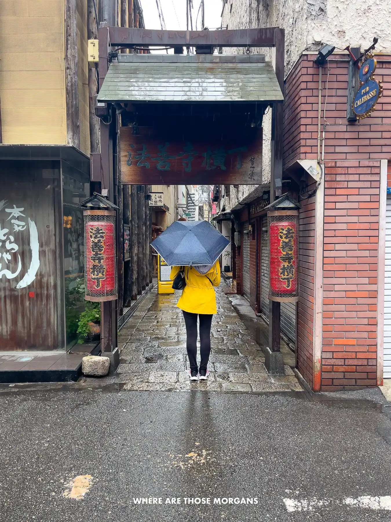 Kristen from Where Are Those Morgans walking down Hozenji Yokocho in Osaka on a rainy day