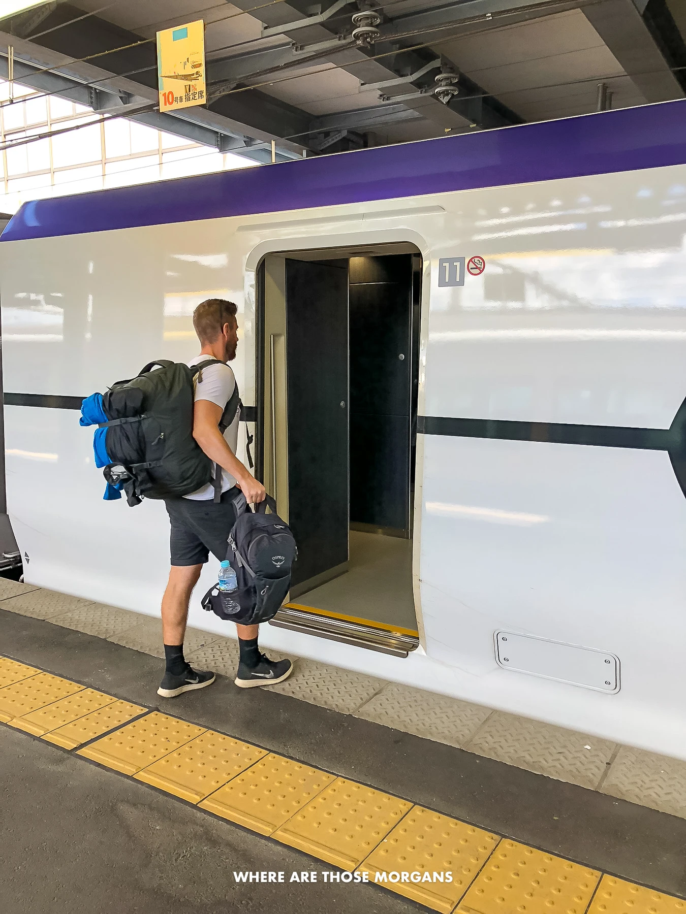 Mark from Where Are Those Morgans walking onto a Shinkansen in Japan