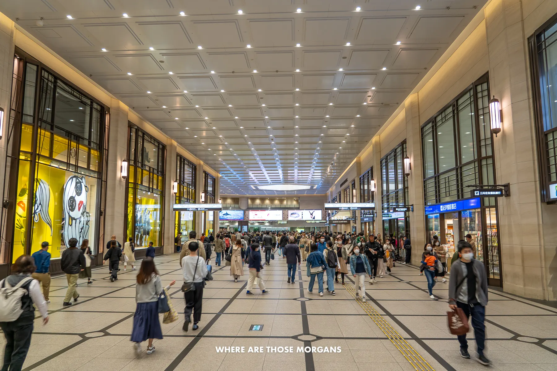 Huge, wide open shopping mall in Umeda with people walking past shops