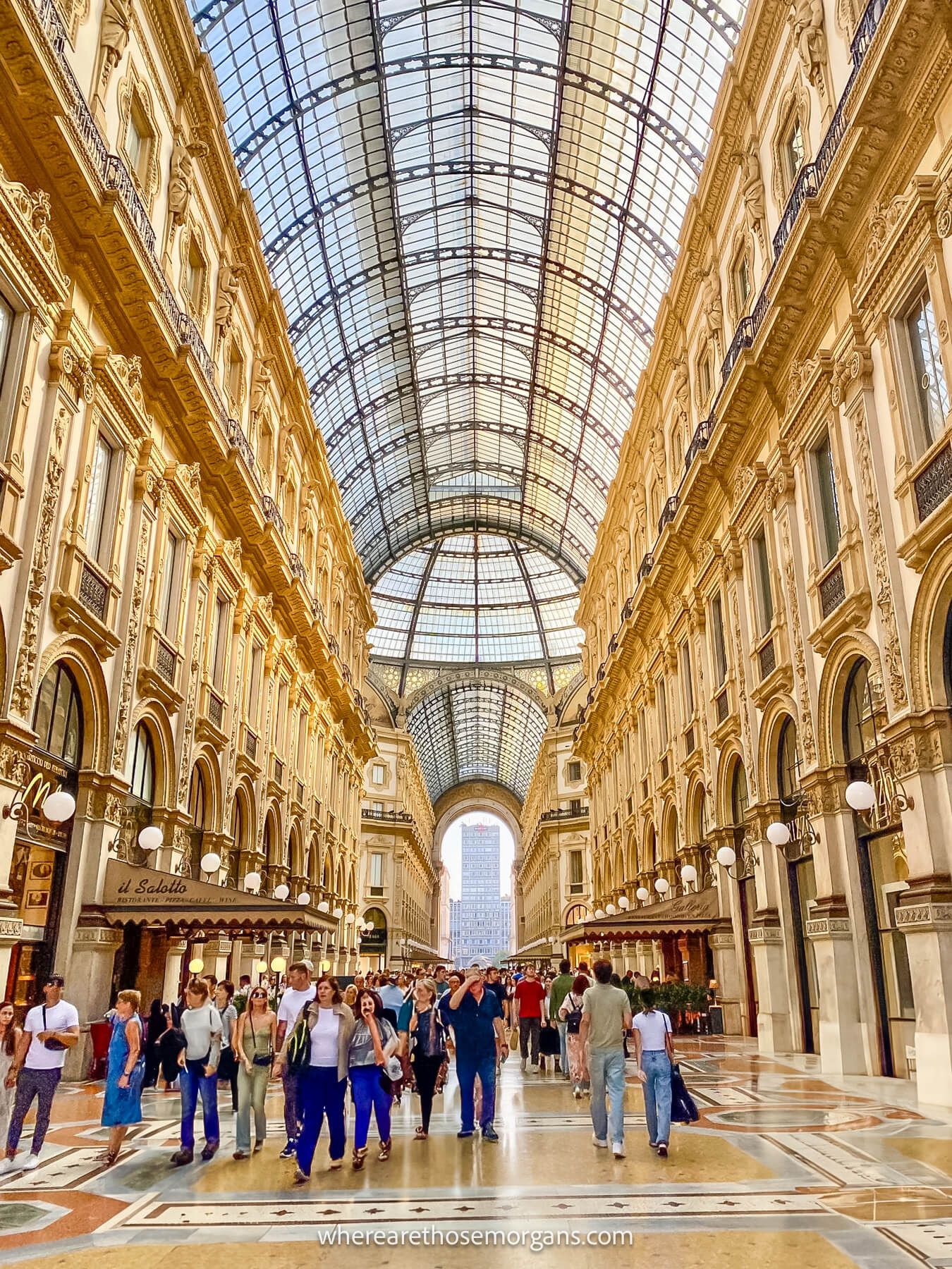 Photo of the inside of a huge shopping gallery with glass roof in Italy